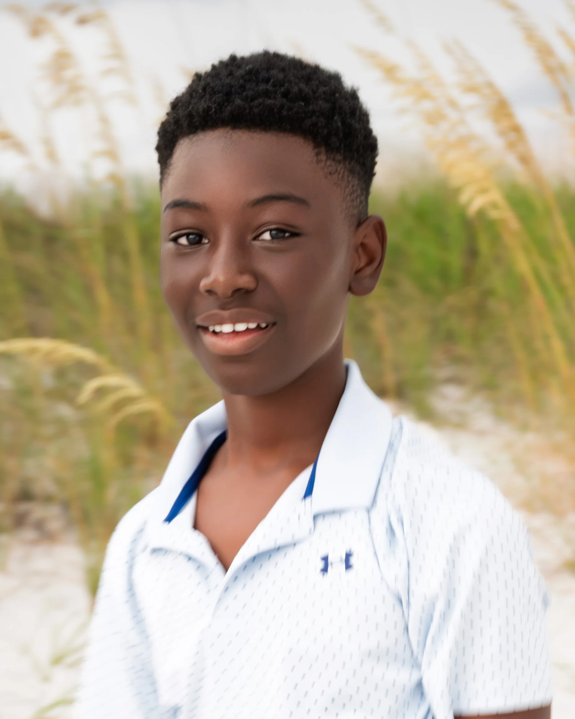 Young man pose for his portrait session on the beach. 