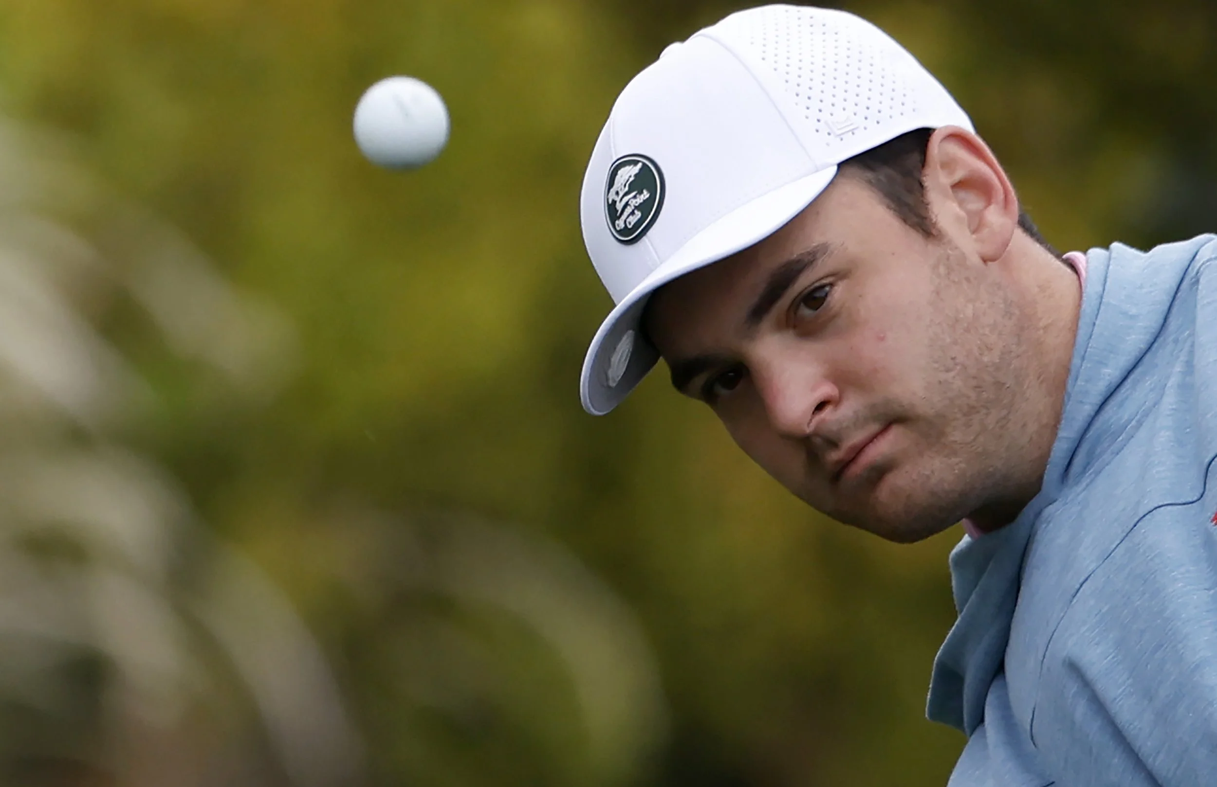 A golfer watches the ball after he hits it at Pebble Beach Golf Links