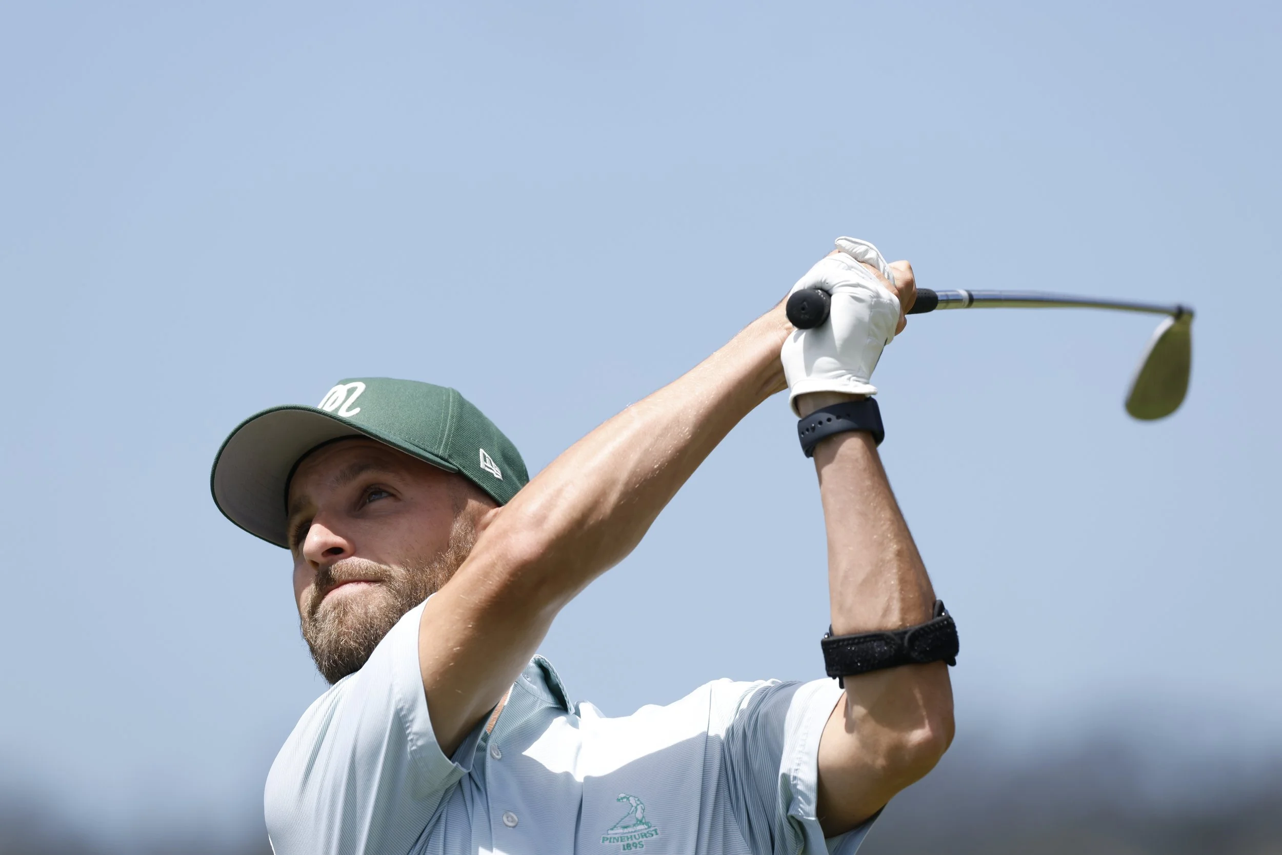 A close up of a golfer hitting the ball at Pebble Beach Golf Links