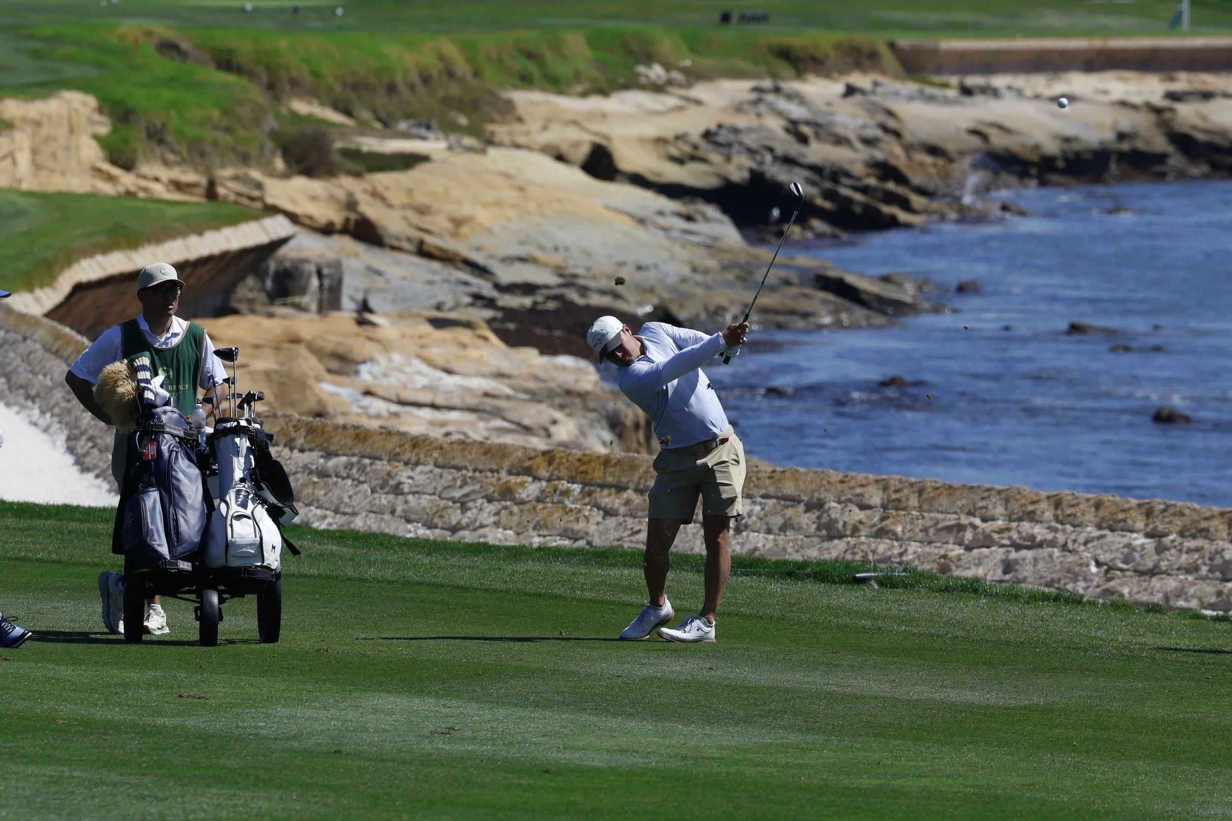 A golfer hits the ball from the fairway on the 18th hole and Pebble Beach Golf Links