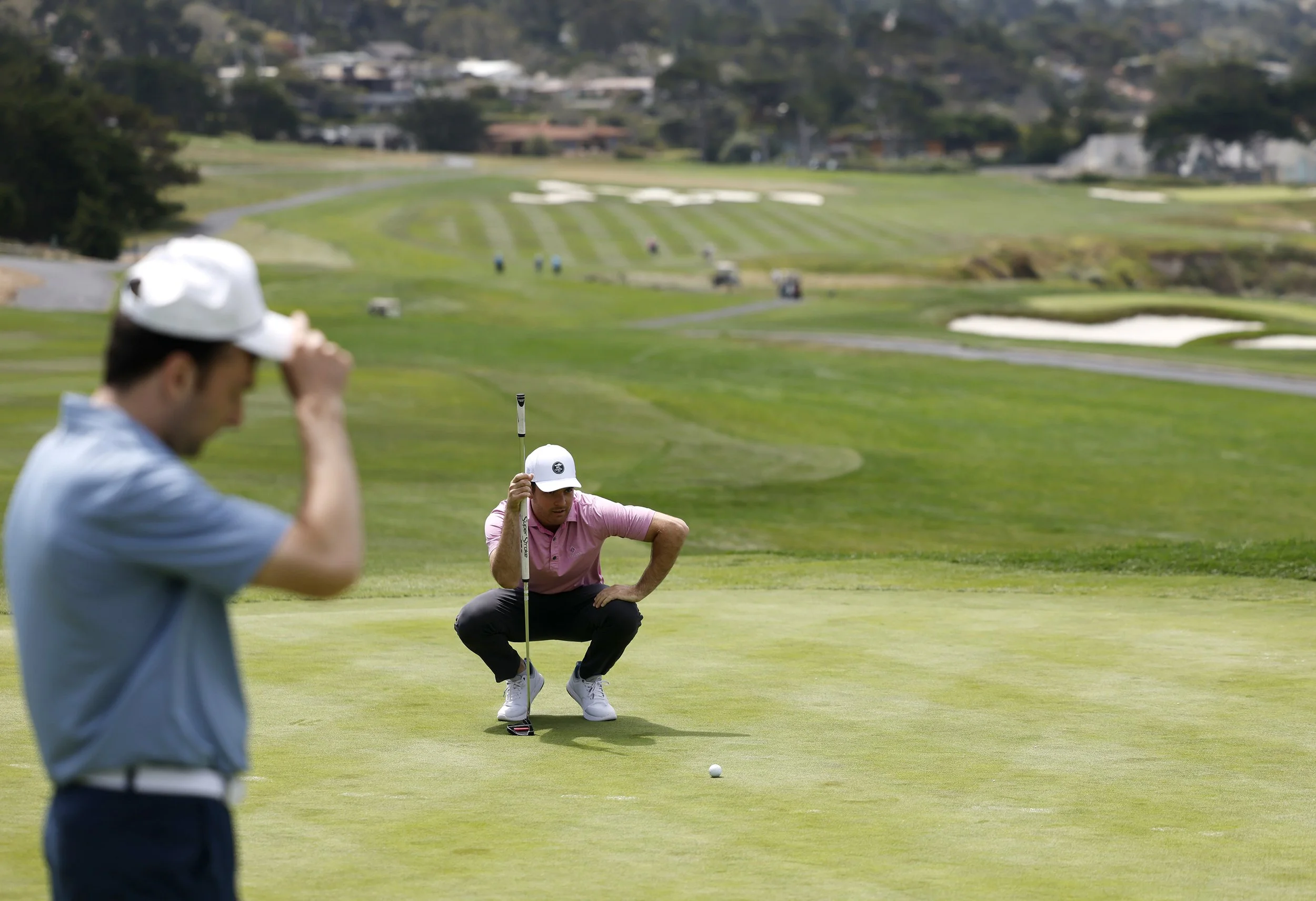 A golfer lines up his putt on the 8th Hole at Pebble Beach Golf Links