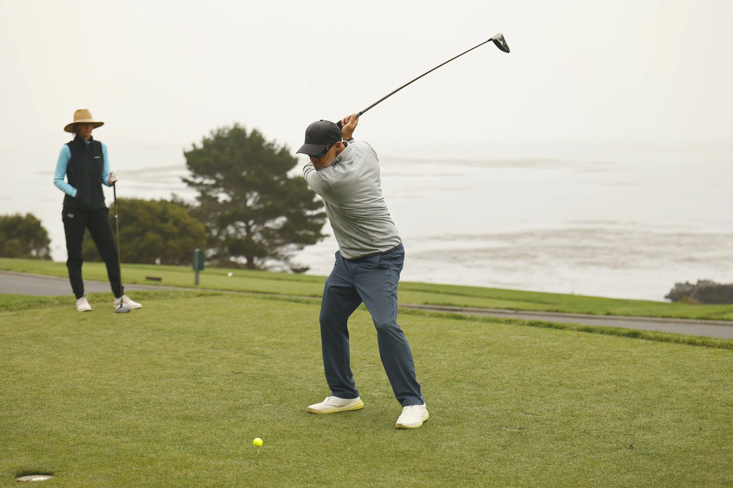 A golfer tees off at Pebble Beach Golf Links