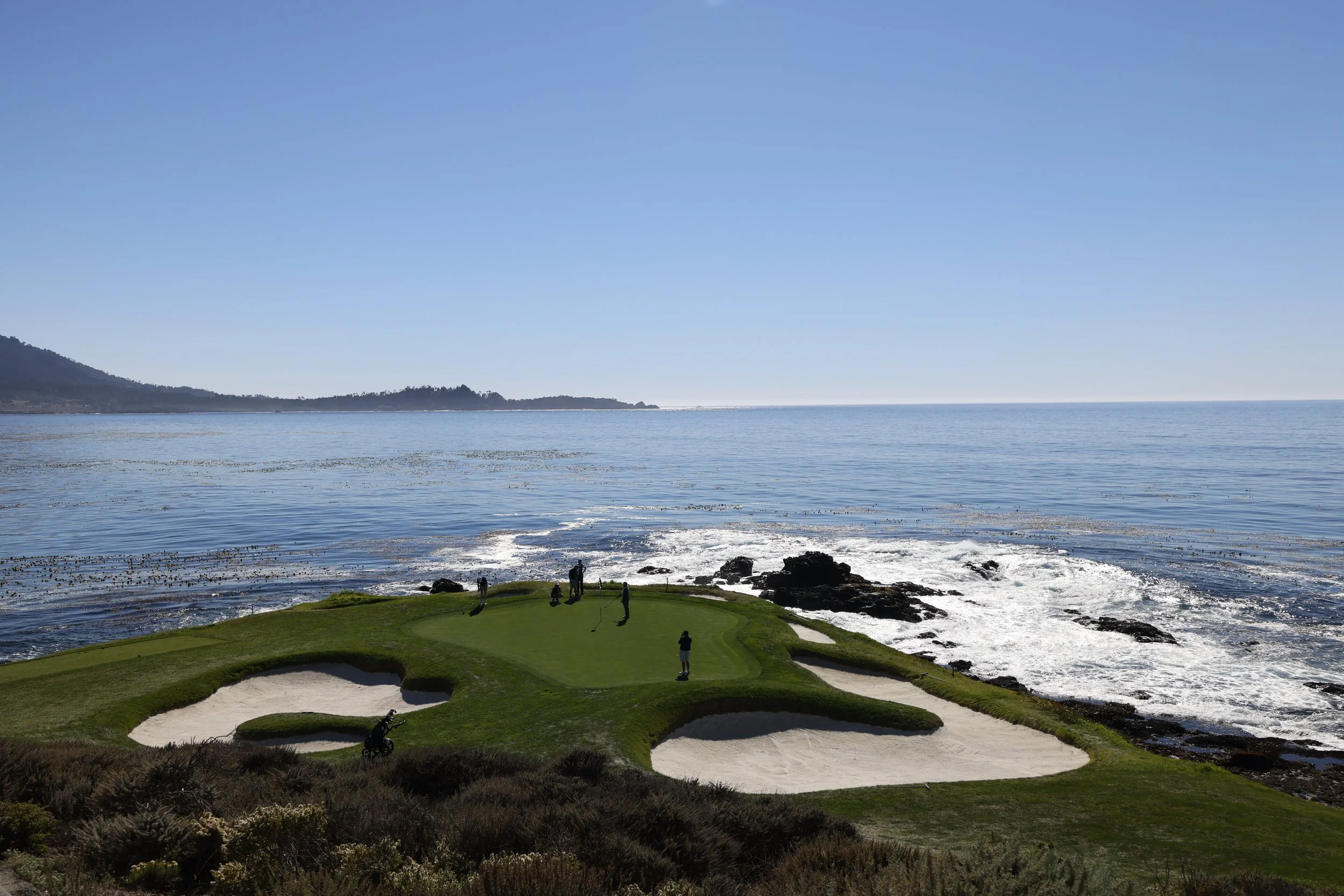Golfer putt on hole 7 at Pebble Beach Golf Links