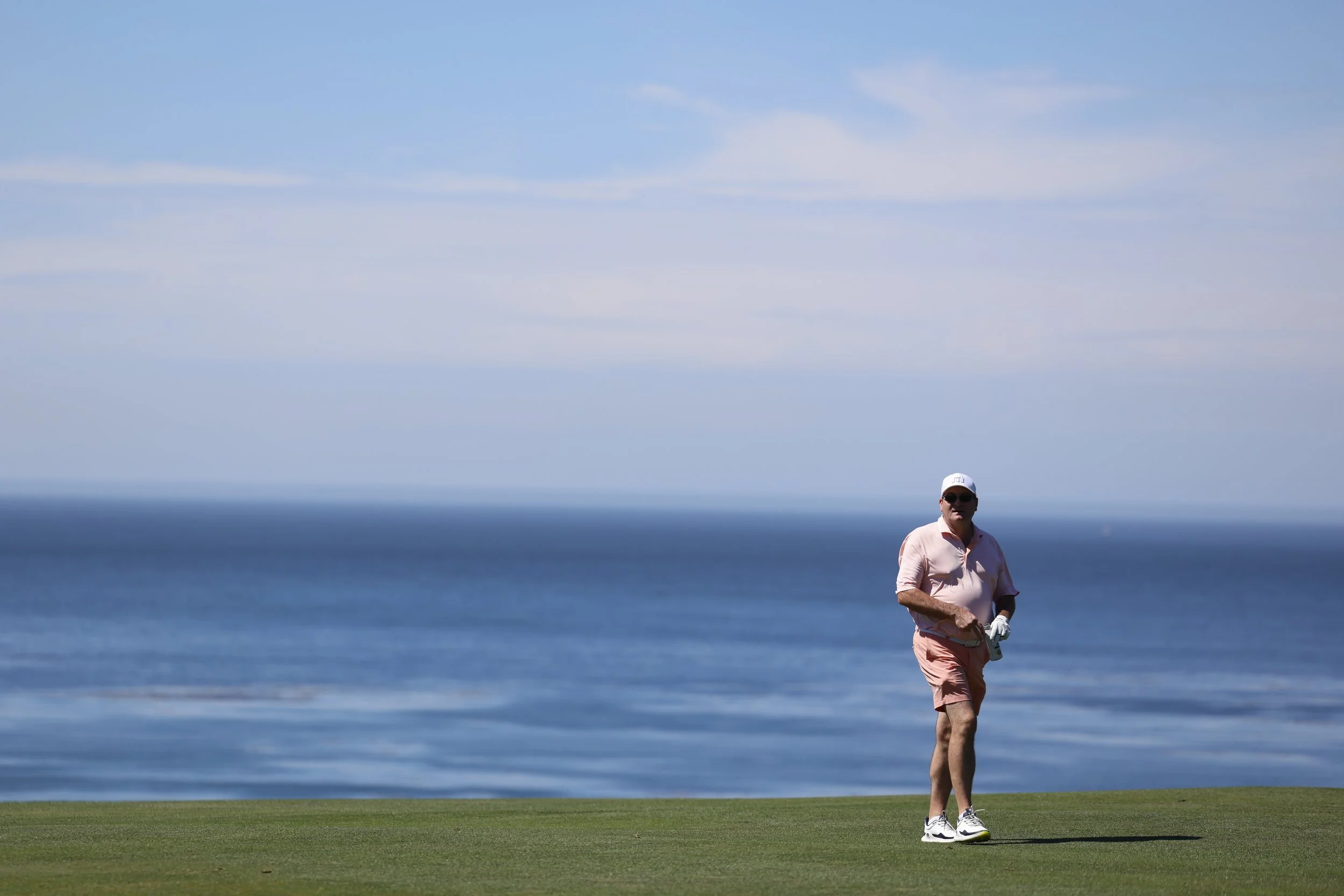 A golfer walks Pebble Beach golf Links