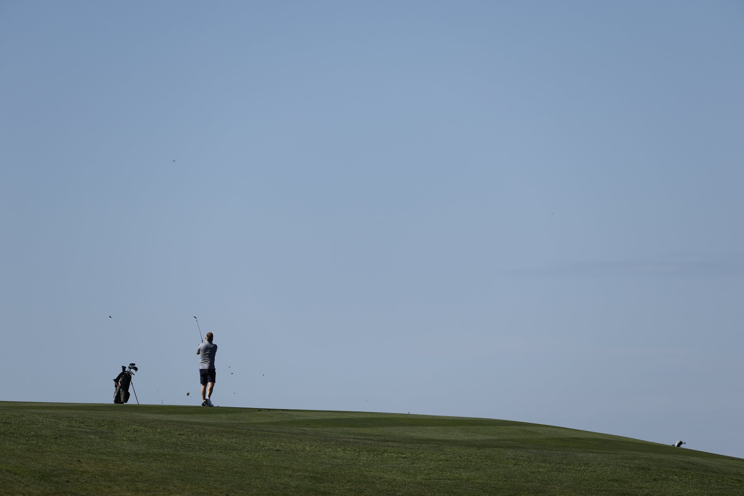 A golfer hits the ball on the 6th hole at Pebble Beach Golf Links