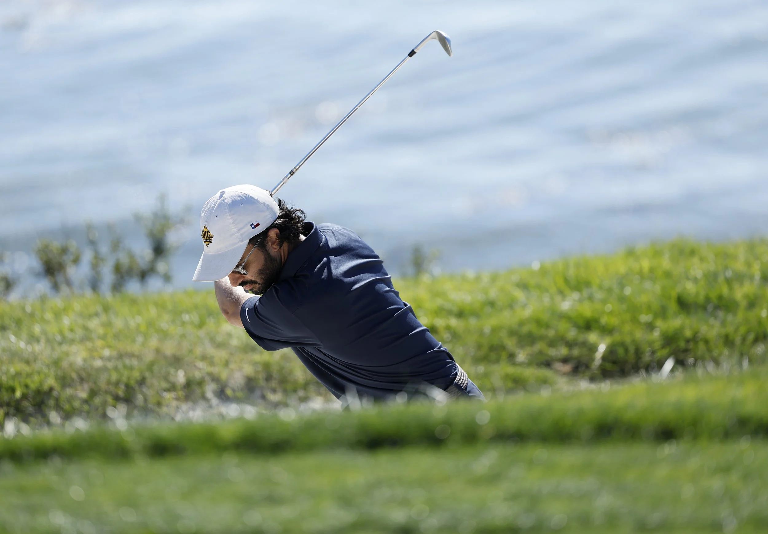 A golfer hits the ball out of a sand trap on Hole 7 at Pebble Beach Golf Links.