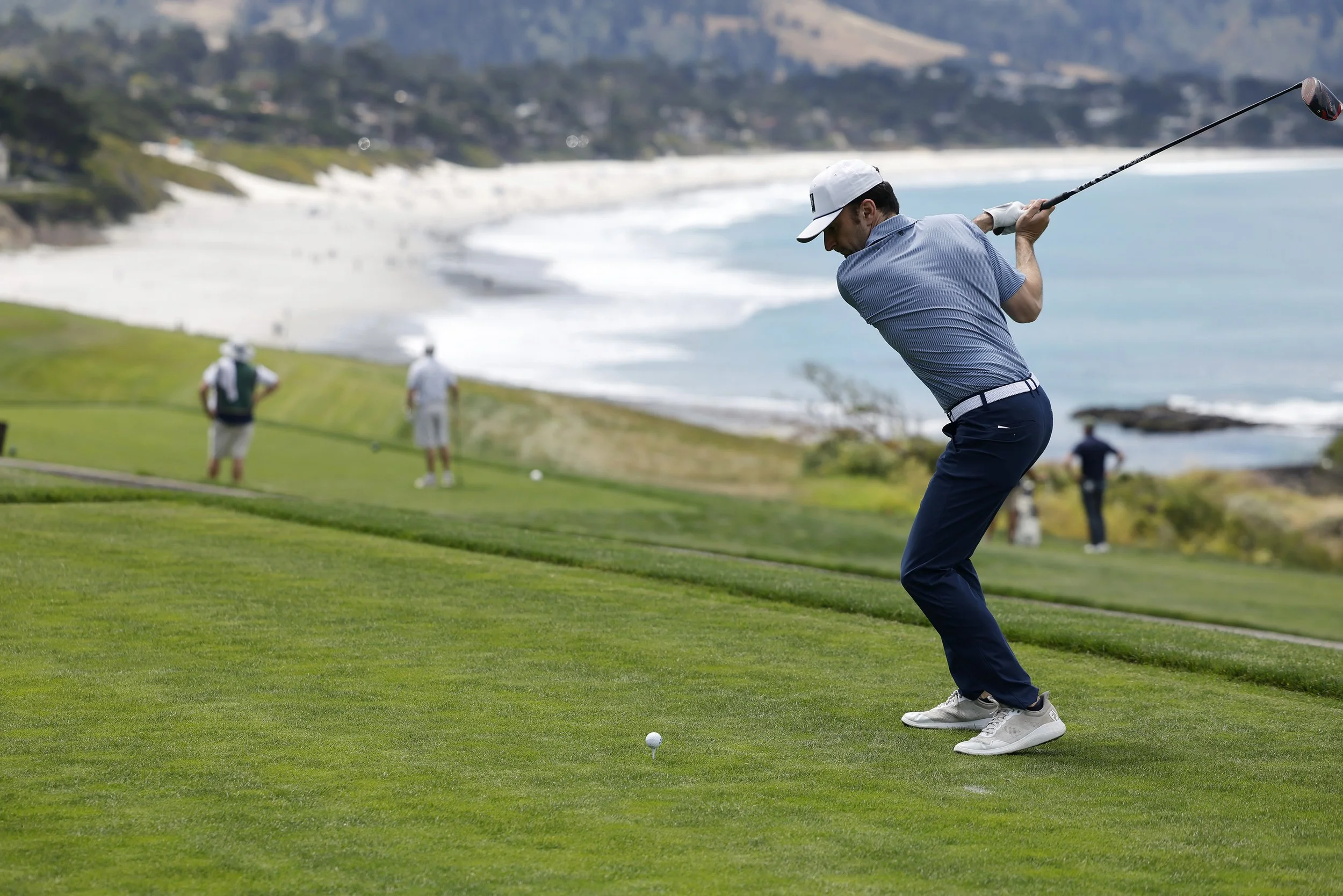 A golfer hits the ball from the Tee on the 12th hole at Pebble Beach Golf Links