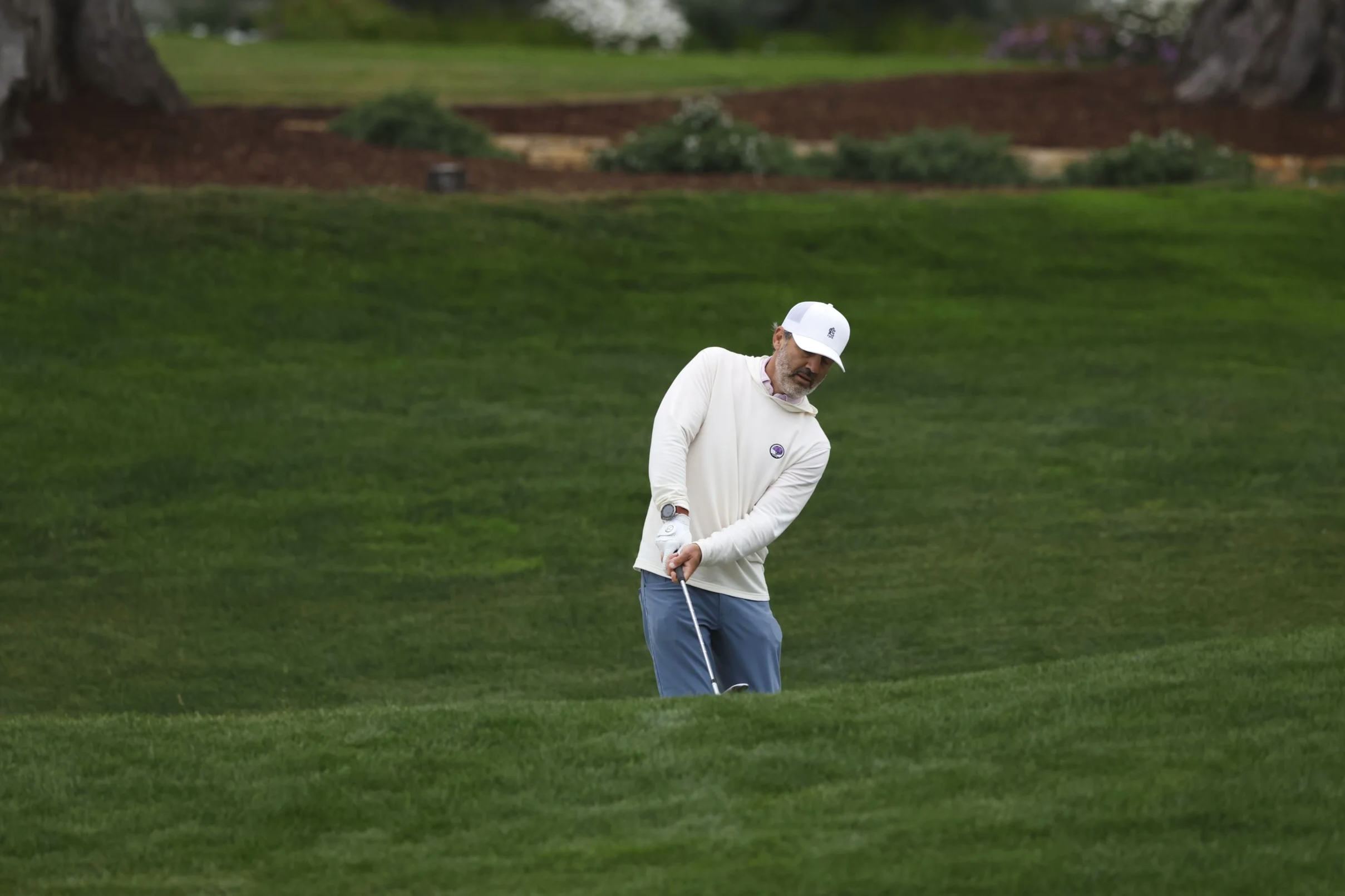 A golfer hits the ball out of a sand trap on the 3rd hole at Pebble Beach golf Links