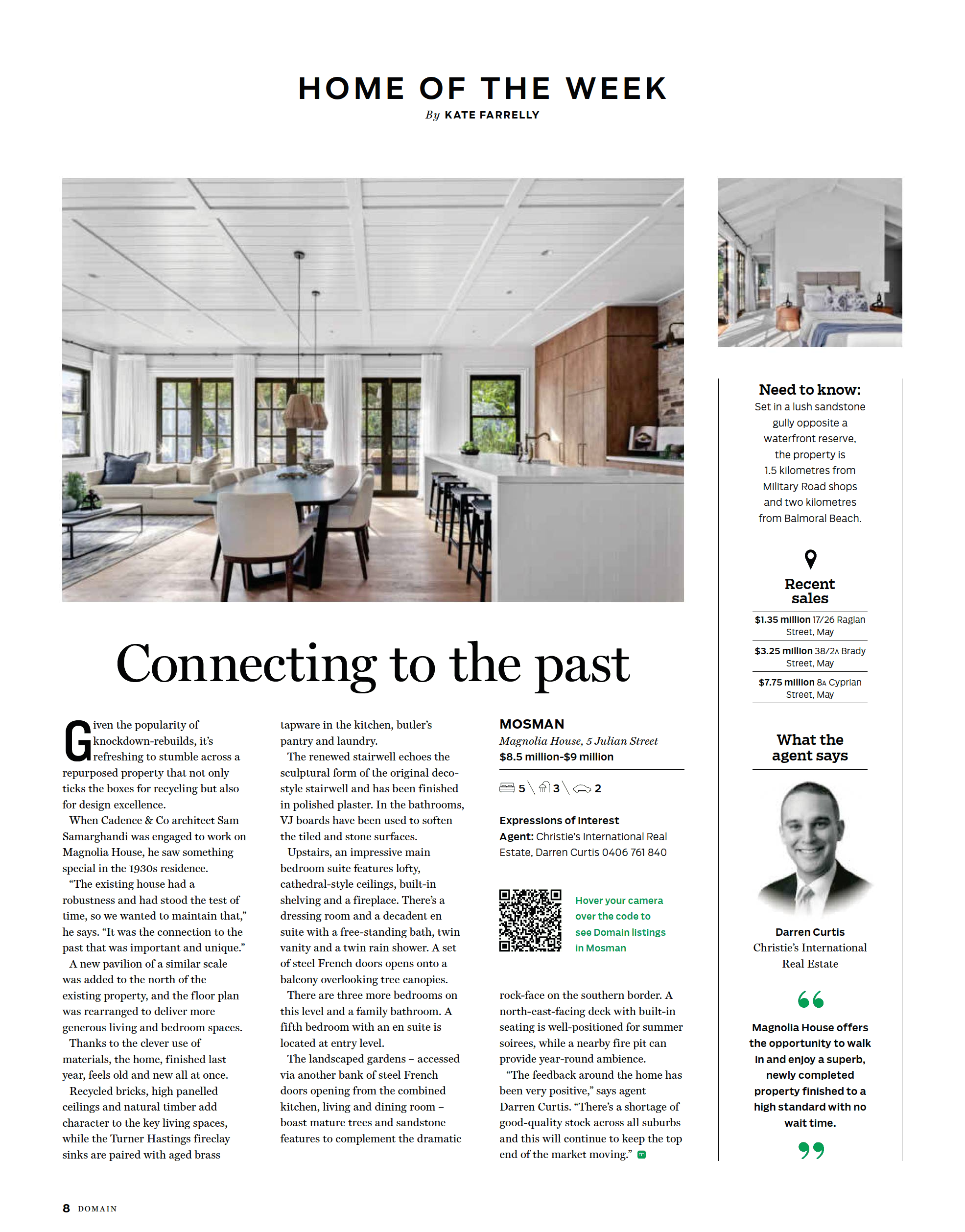 A spacious, modern living and dining area with large windows, white curtains, a beige sofa, a dining table with chairs, and a kitchen island with bar stools.