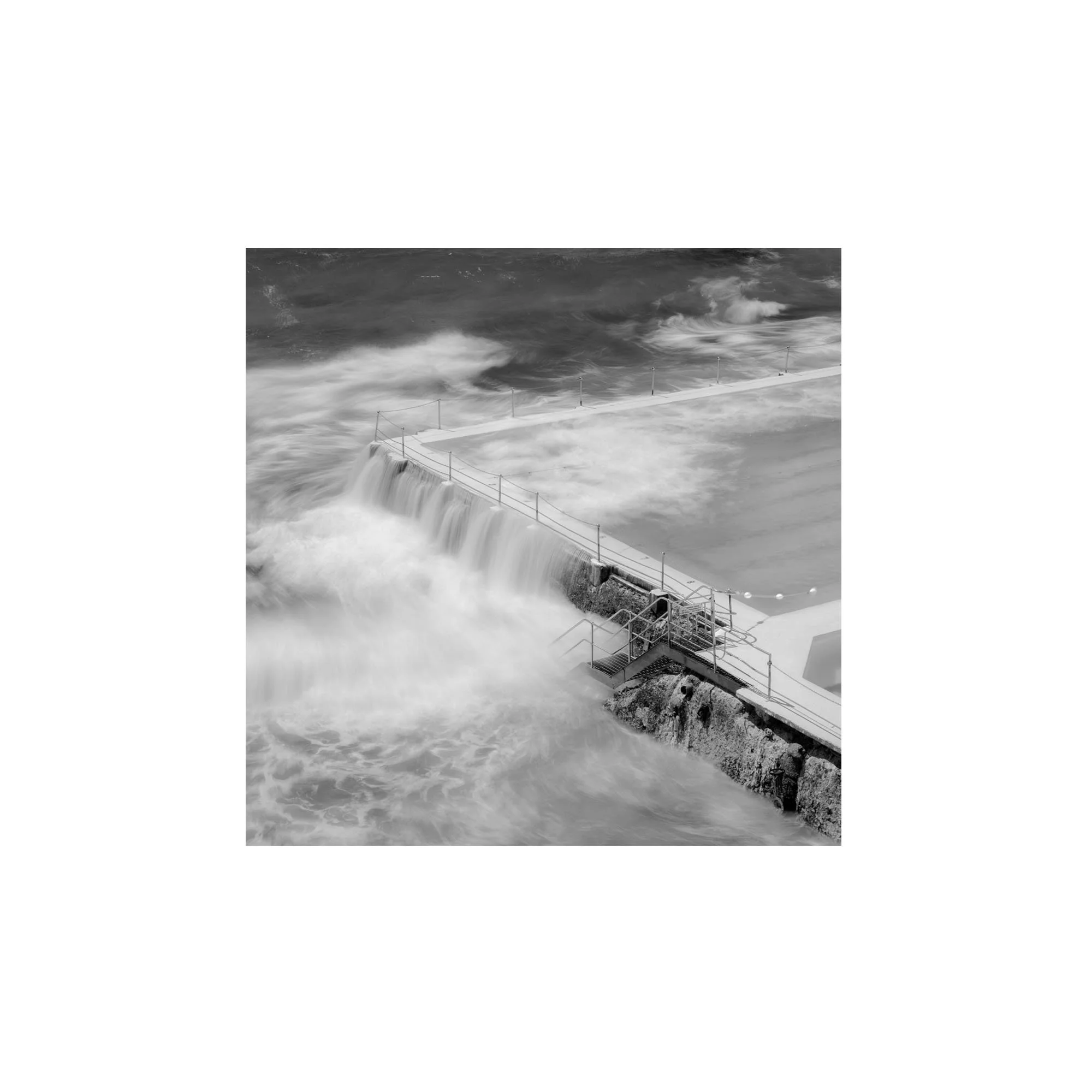 A contemplative black and white photograph of Bondi’s ocean pool, capturing resilience, flow, and quiet strength through long exposure seascape photography.
