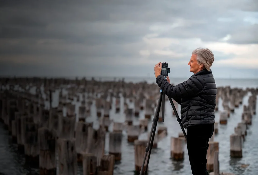 Diane photographing old pier posts at first light