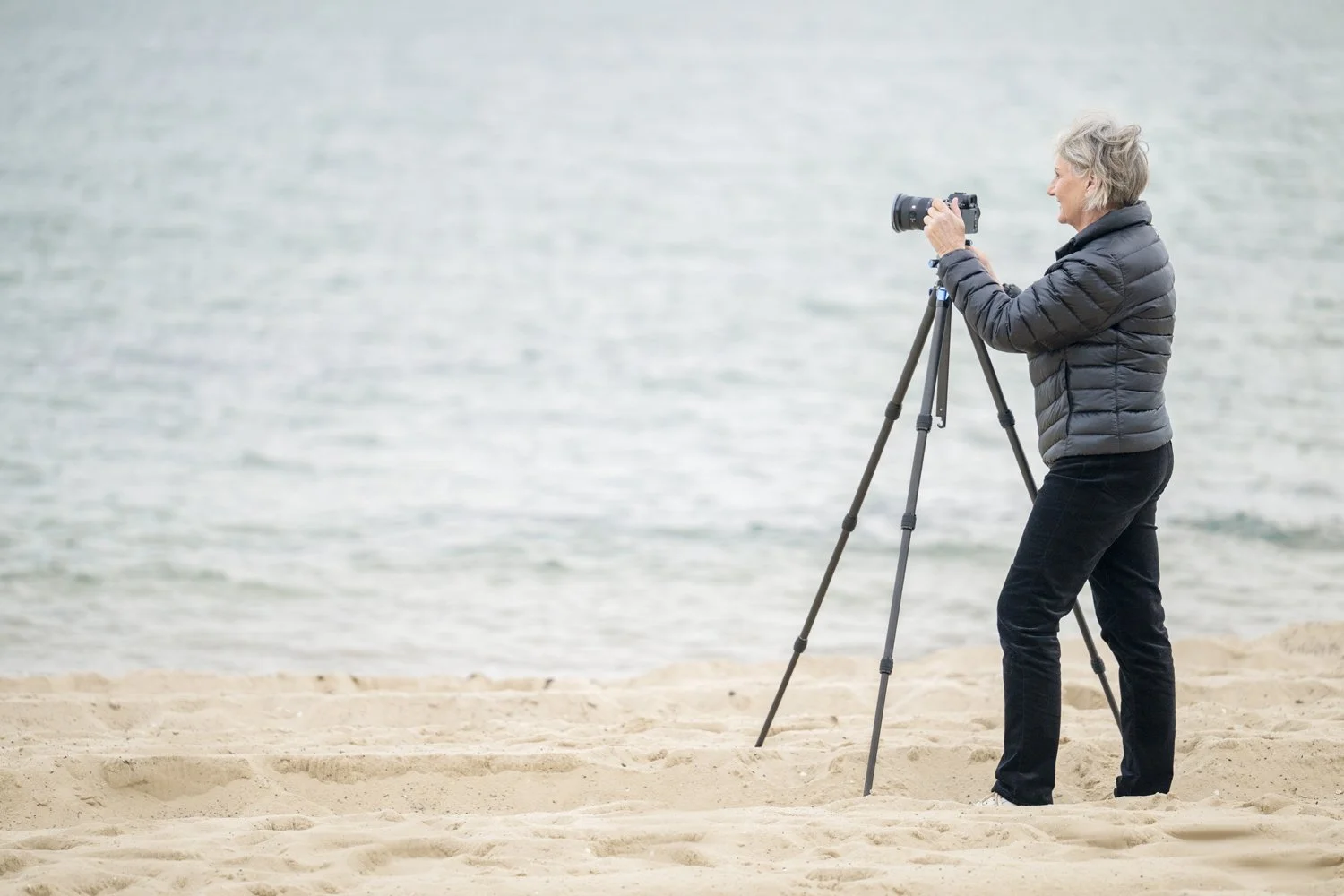 Diane Armstrong on the shore with her camera on a tripod