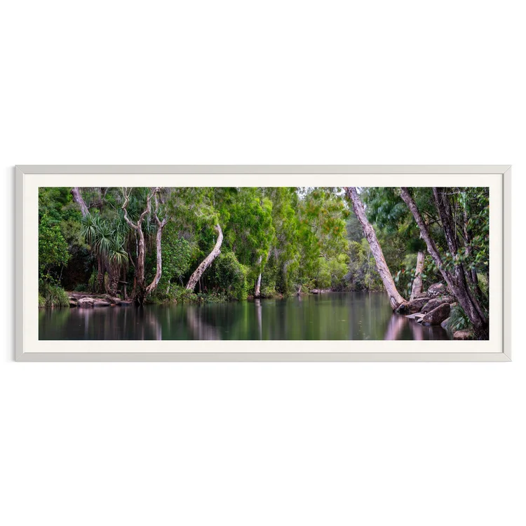 The Secret Pool in a white frame: a still creek pool among paperbarks