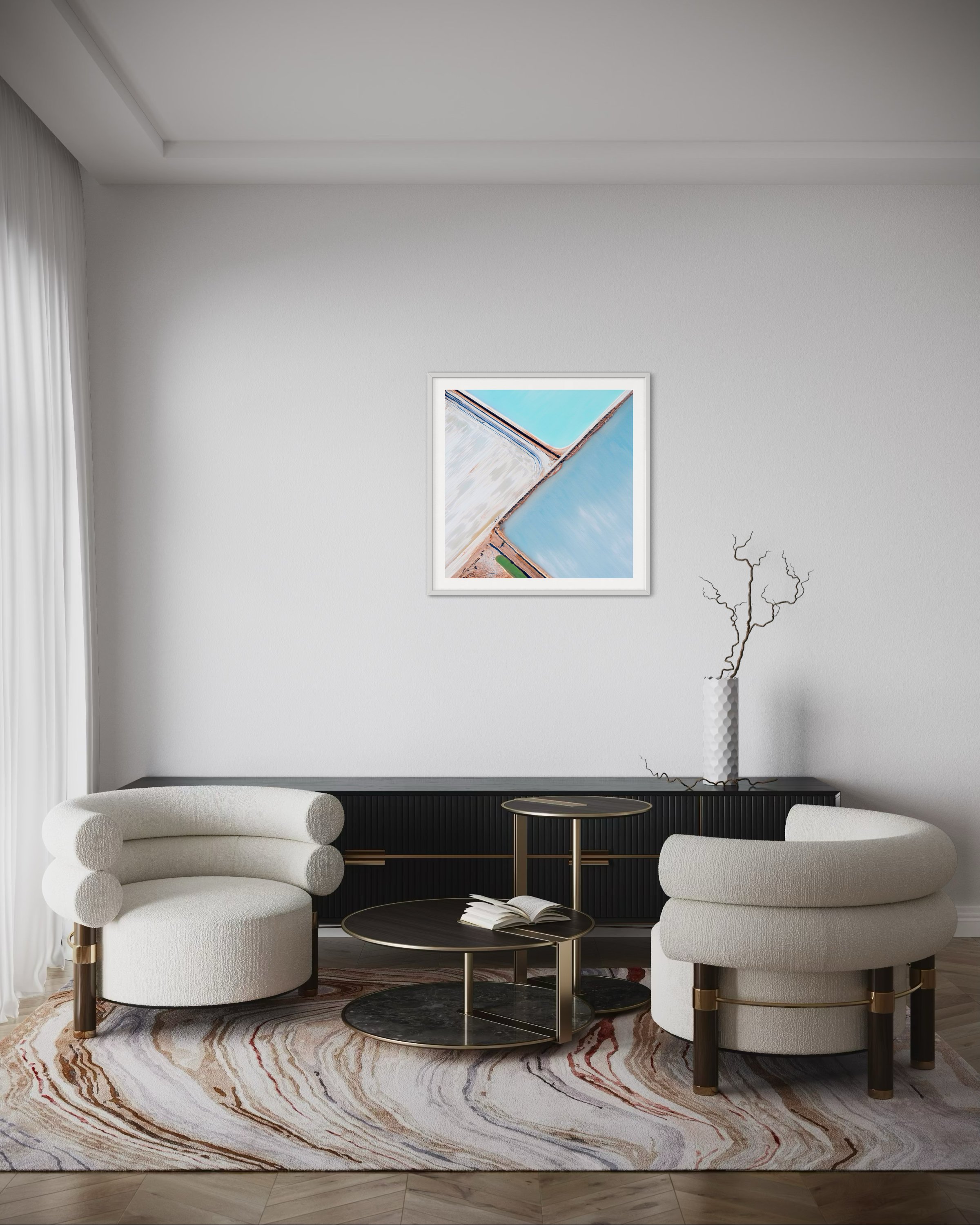 A large square print in a frame in a lounge room for scale.