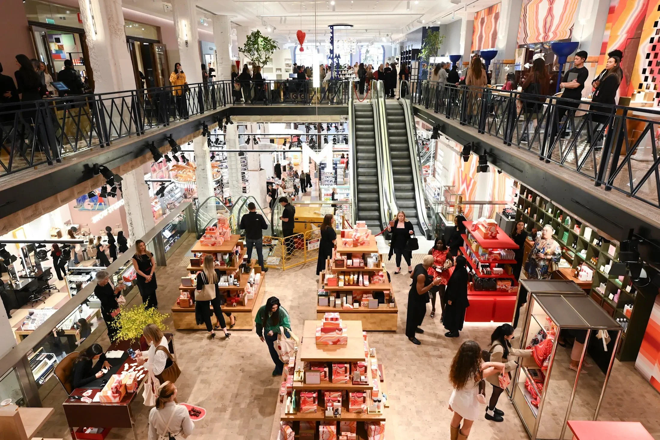A picture of the busy interior of Melbourne's new MECCA store with customers and products featured.
