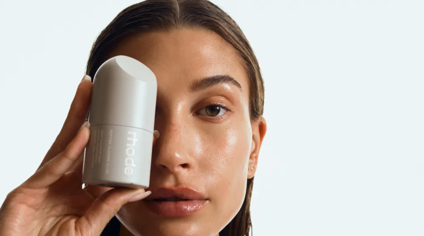Photo of Hailey Bieber holding a rhode product