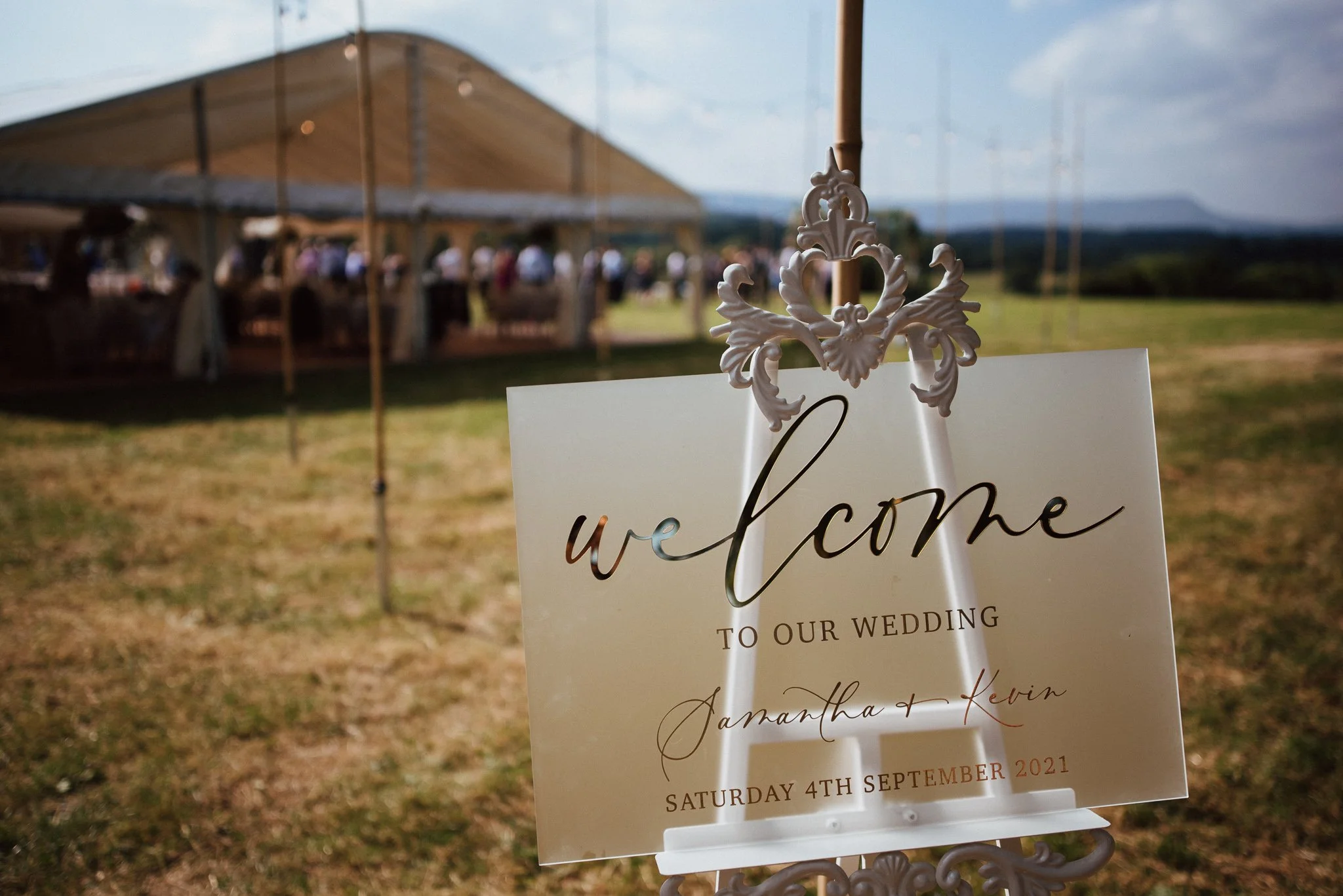 Wedding marquee welcome sign infron of the wedding reception