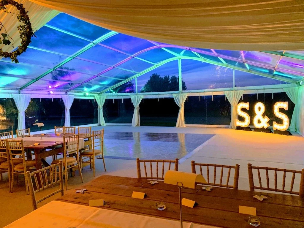Wedding Marquee Reception at night looking at the dance area washed in green and purple LED lighting