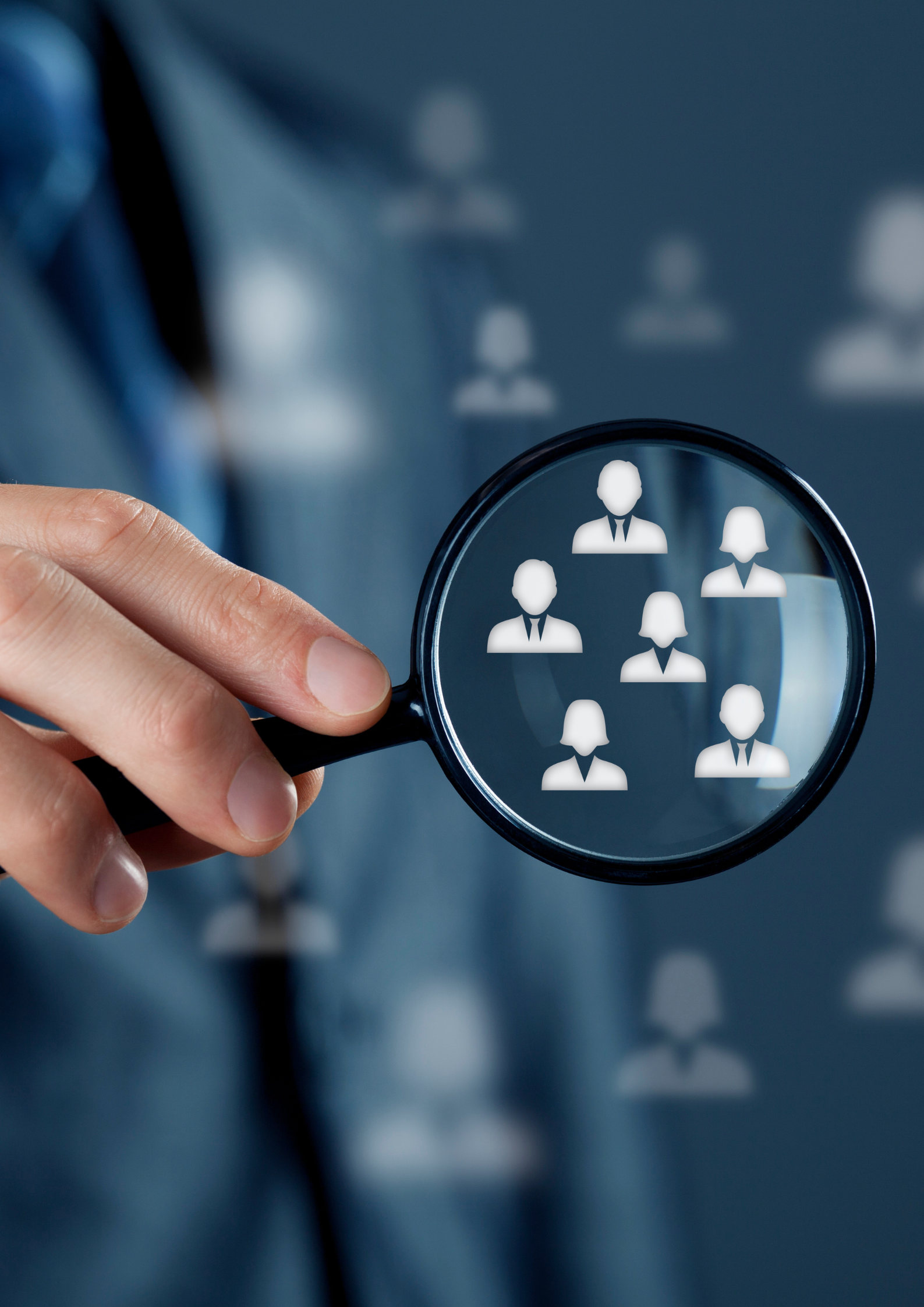 Person holding a magnifying glass with icons of people related to recruitment or social network displayed through it.