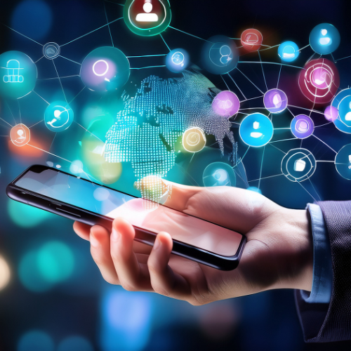 Person holding a smartphone with digital icons and a world map hologram above it, representing global connectivity and technology.