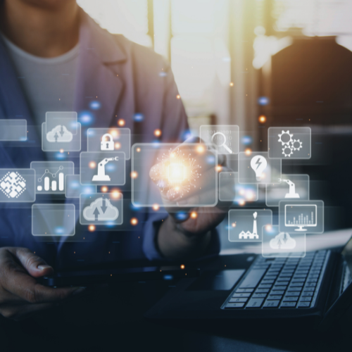 A person using a laptop with floating technology icons representing data, automation, and scientific research.