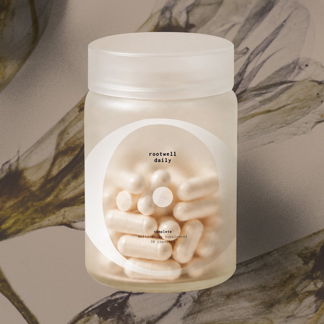 A white bottle containing capsules labeled 'rootwell daily' and 'complete multi detox supplement 30 capsules' against a marble surface background.