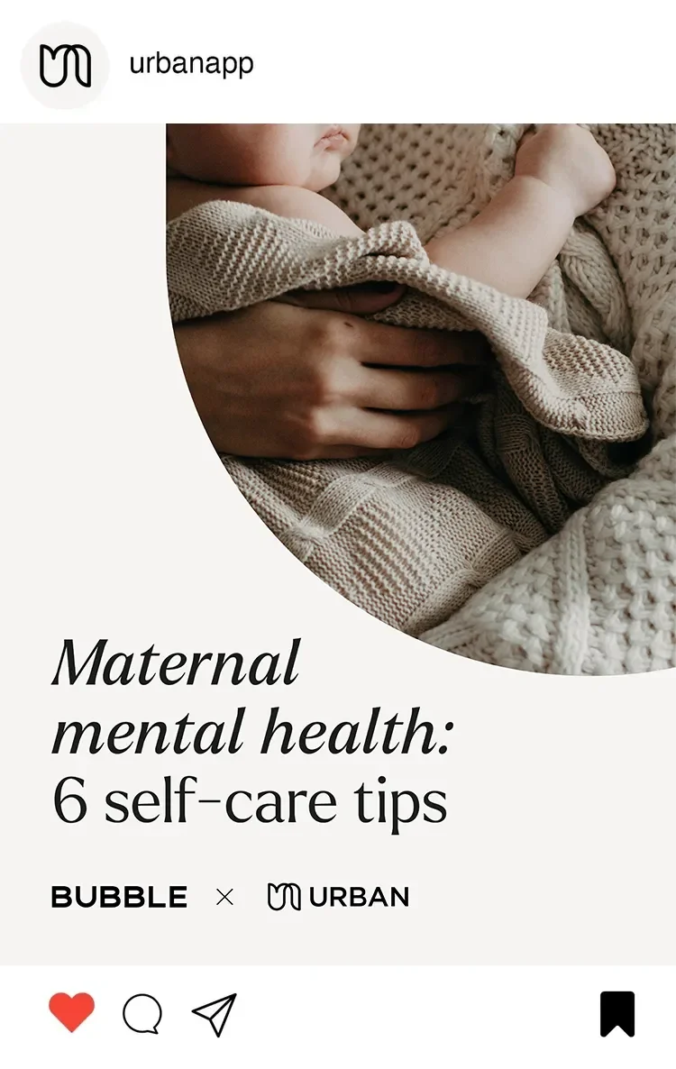 Close-up of a parent holding a sleeping baby wrapped in a beige knitted blanket, focused on maternal mental health and self-care tips