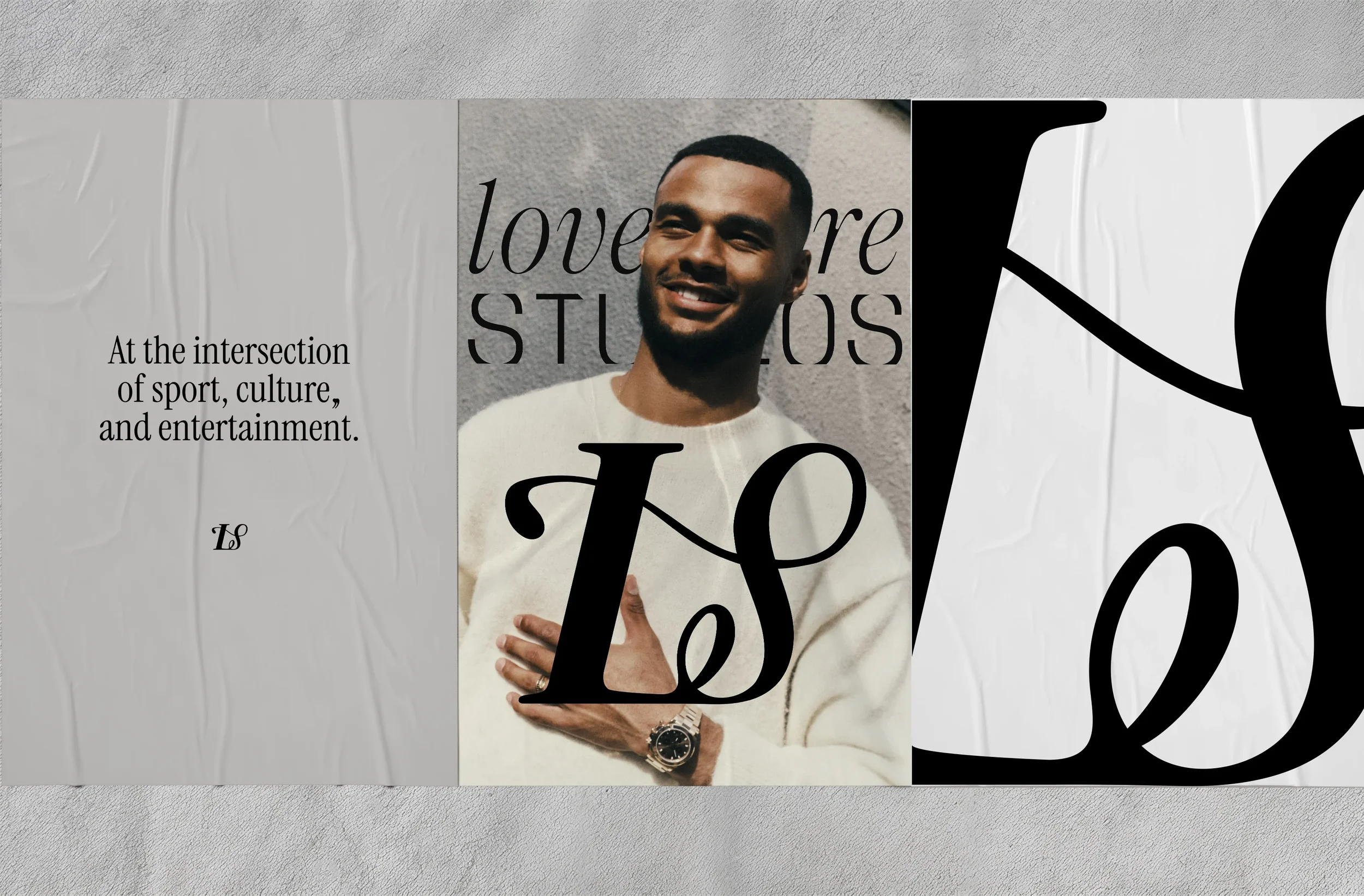 A person with a beard smiling, wearing a white sweater and a wristwatch, standing against a textured wall, with overlaying black and white decorative text.