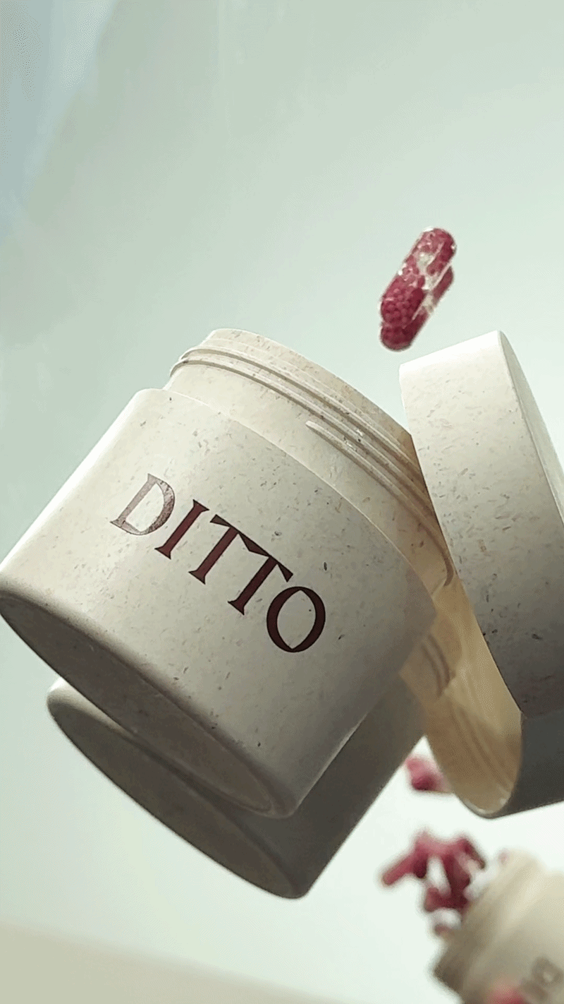 A pill bottle labeled 'DITTO' with capsules spilling out.