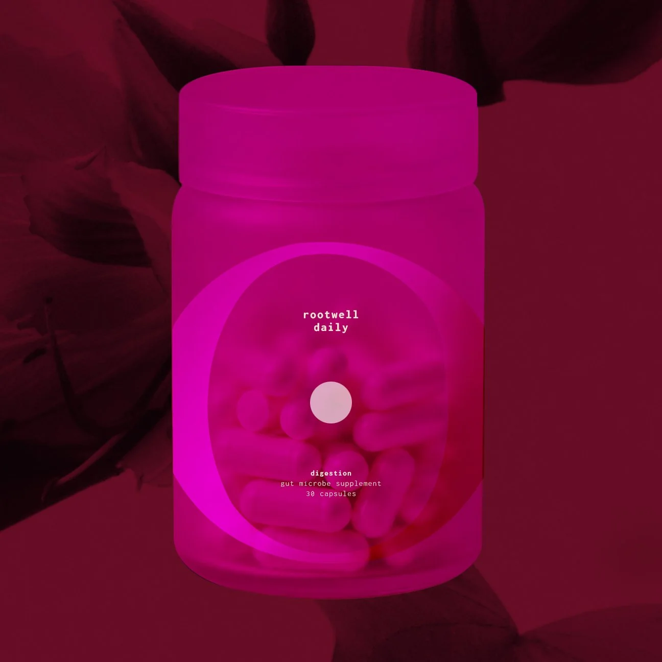 A pink container labeled 'rootwell daily' containing capsules of a gut microbe supplement for digestion.