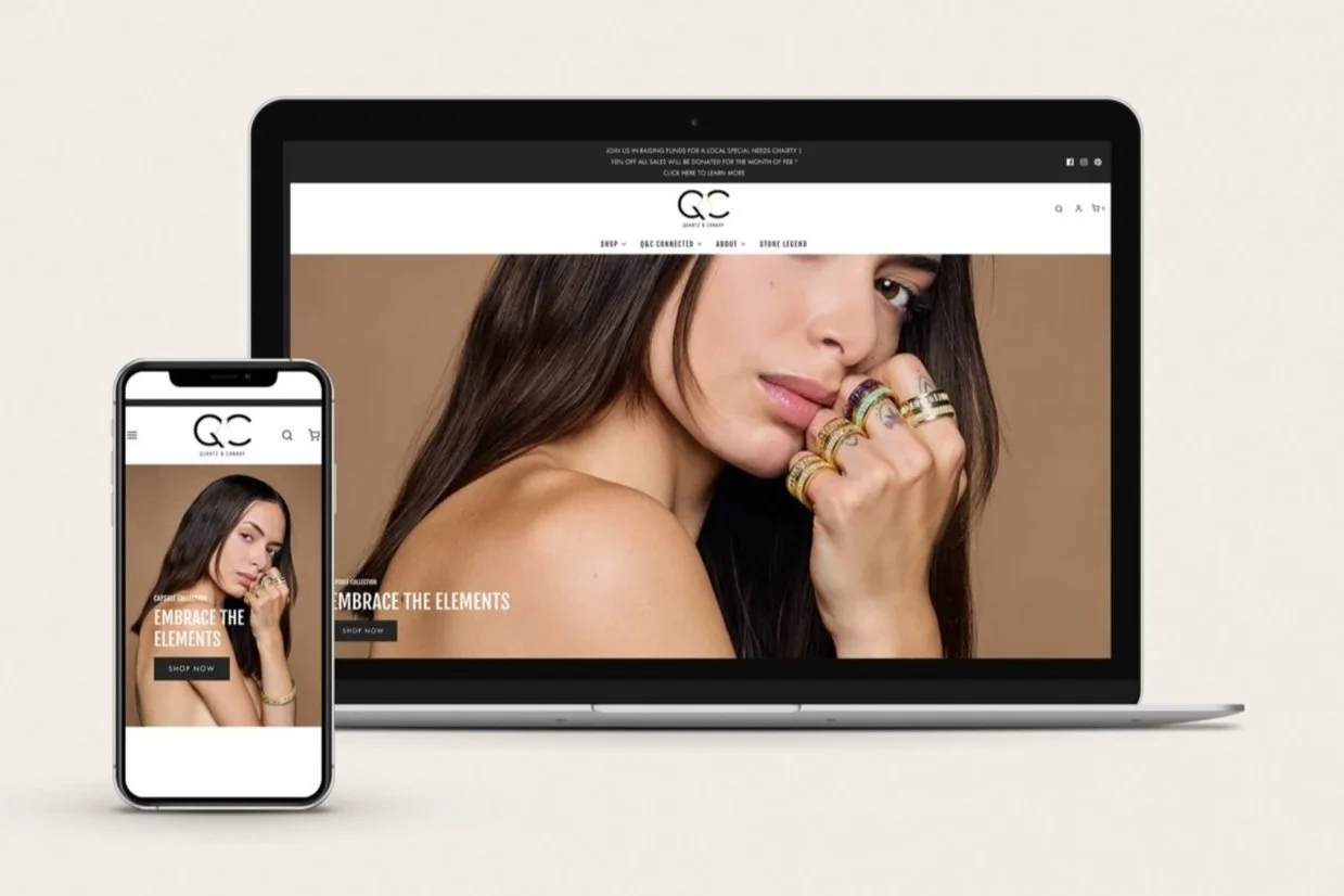 laptop and iphone display of jewlery website, woman holding hand to mouth with lots of gold rings on