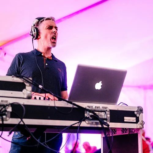 Group of older women wearing 70's style glasses and outfits, dancing at a paarty