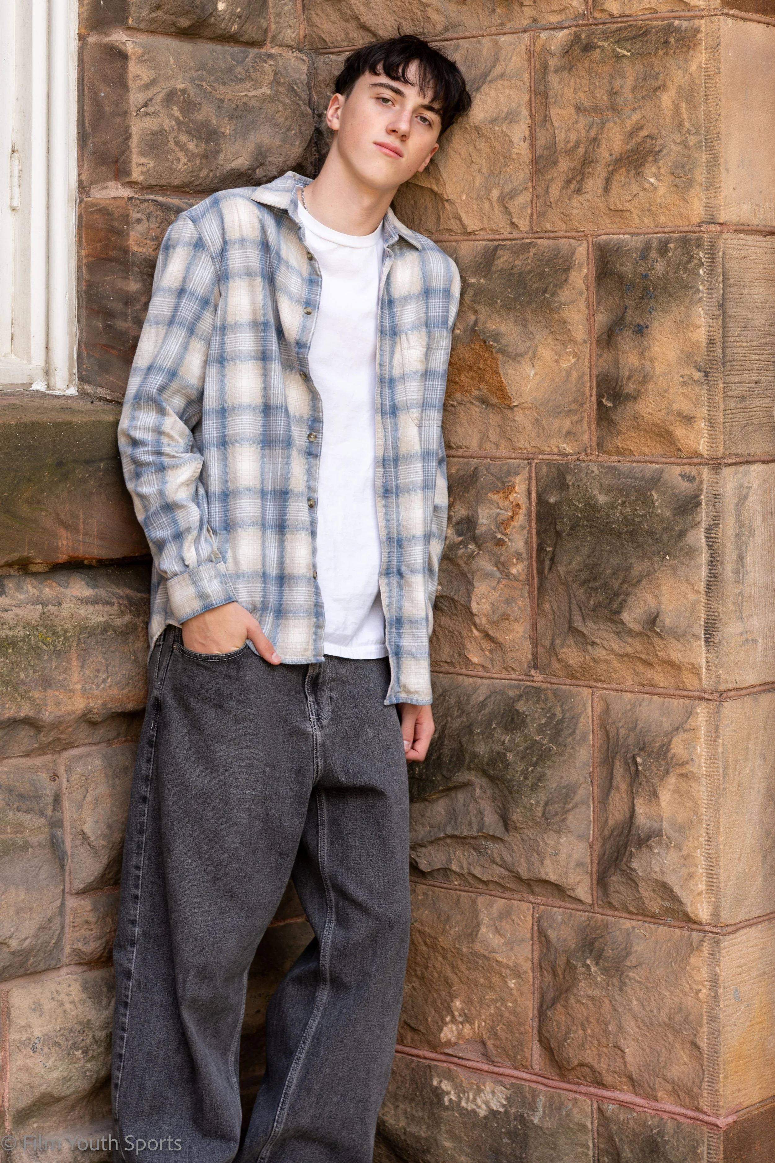 Senior picture in an urban area on large mason red stone