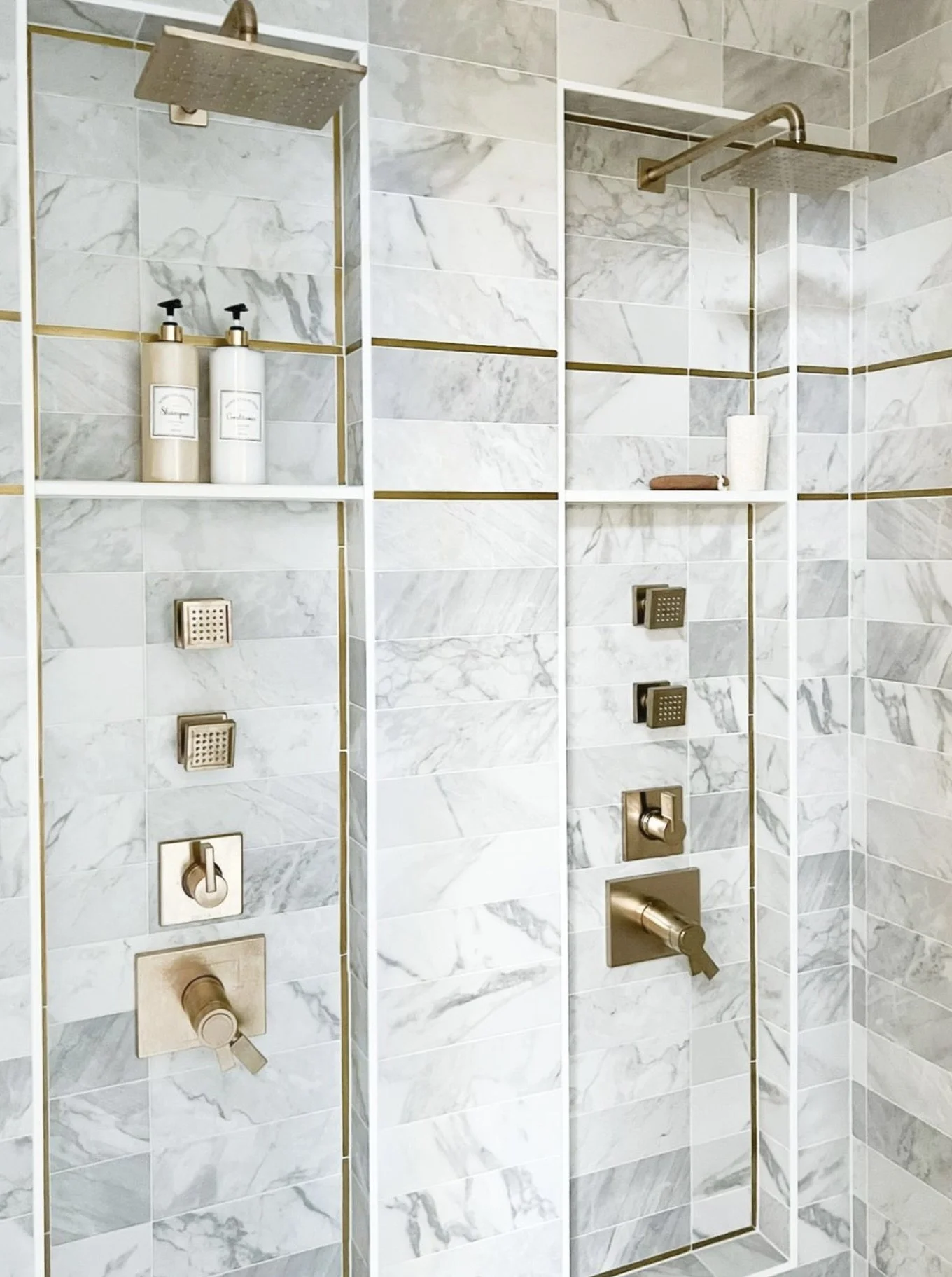 Two-person shower with luxury tile and gold accents