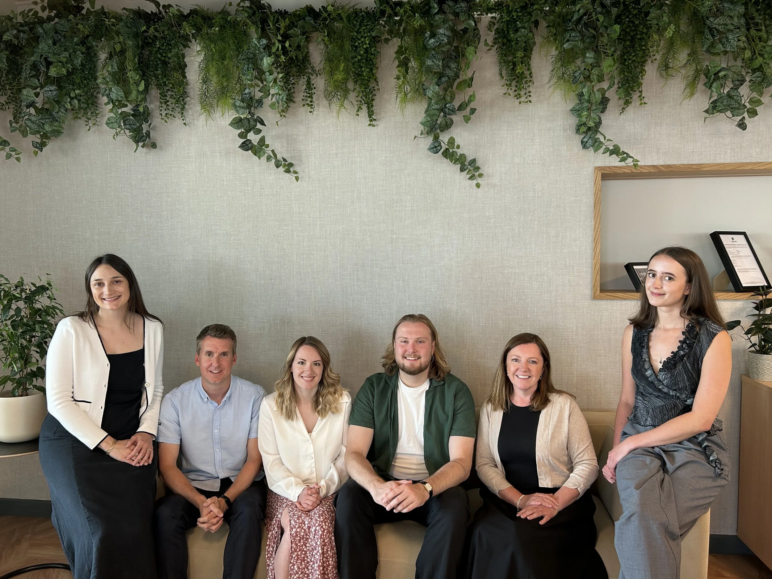 Altitude team sat on a sofa in the office.