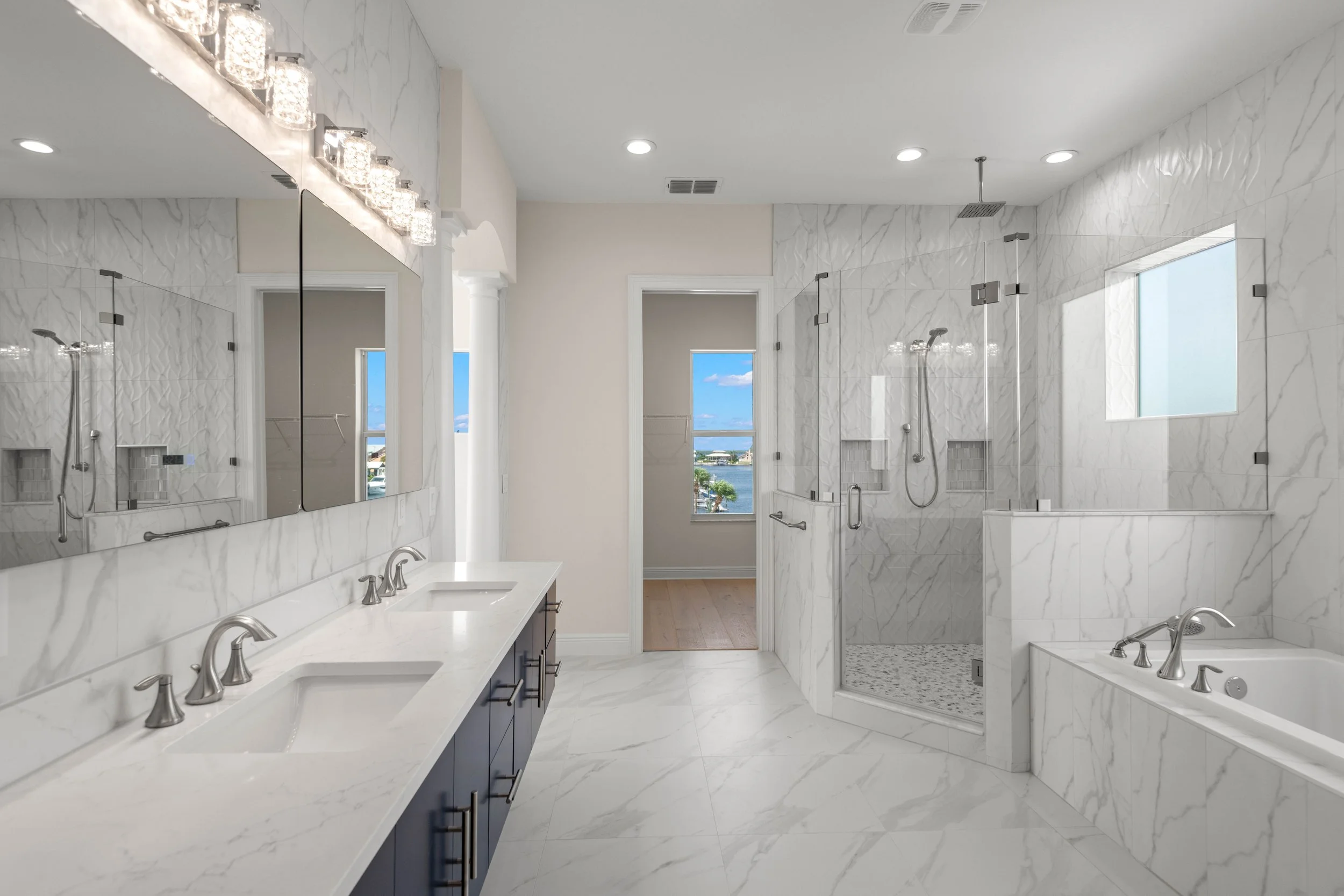 Luxury primary bathroom with marble finishes in Tarpon Springs estate.jpg