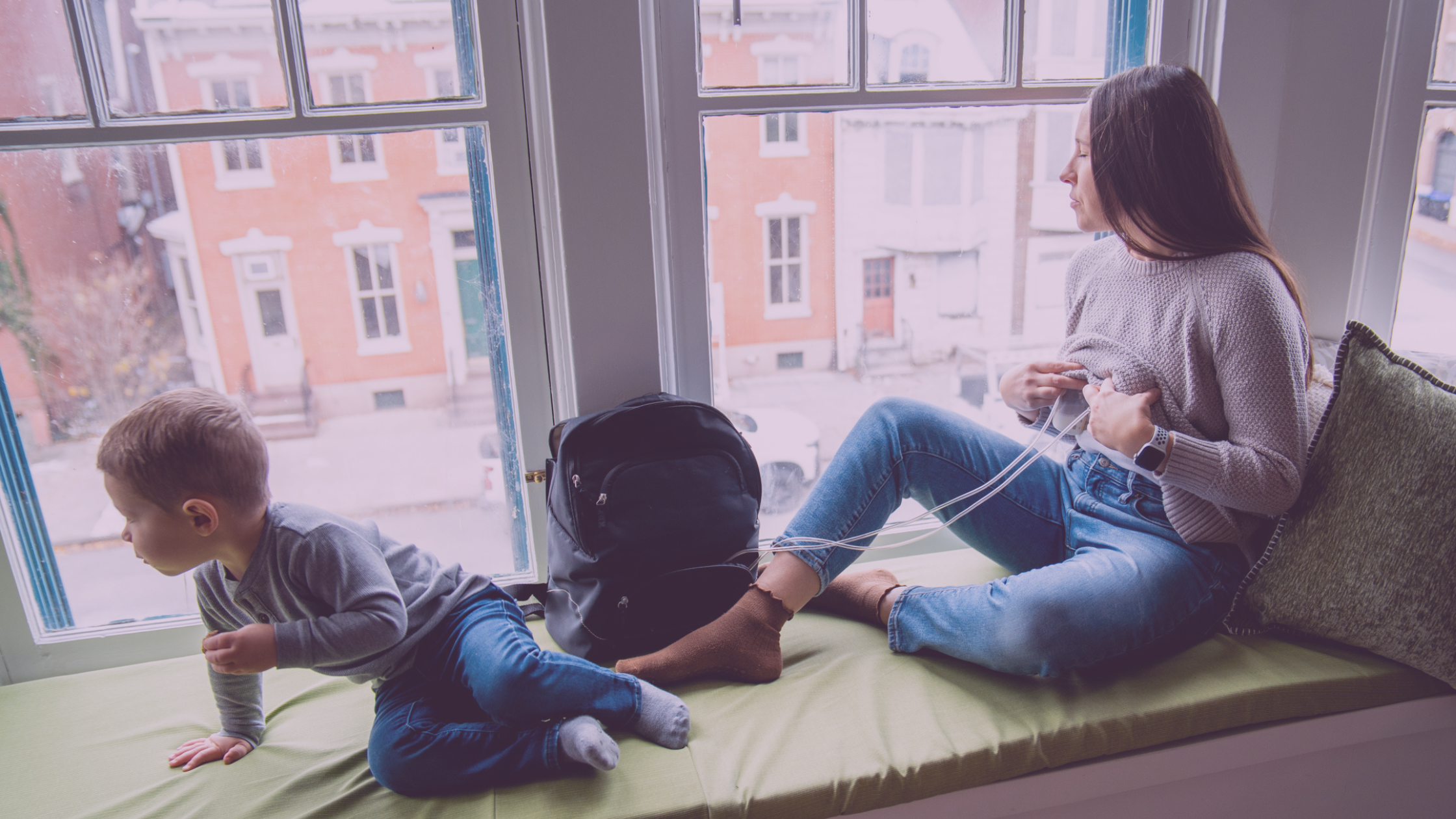 Mom in Window Pumping Breastmilk with Toddler Child with Breastpump