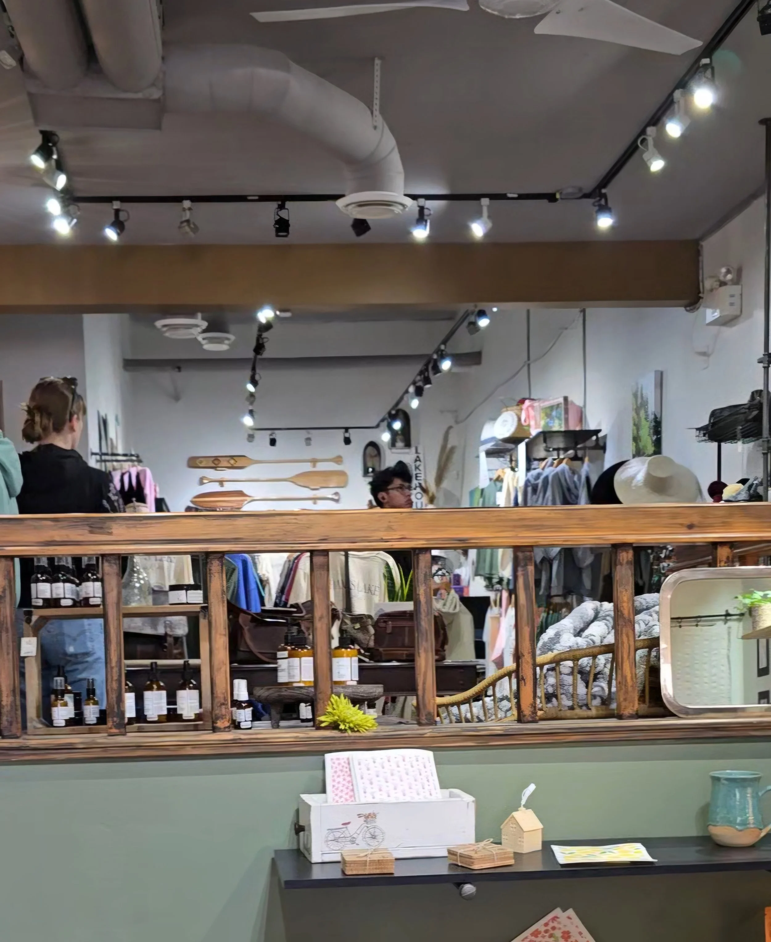 looking inside Salmon Arm local artisan shop called On Alex at clothing, wood and lake life decor and wearable art