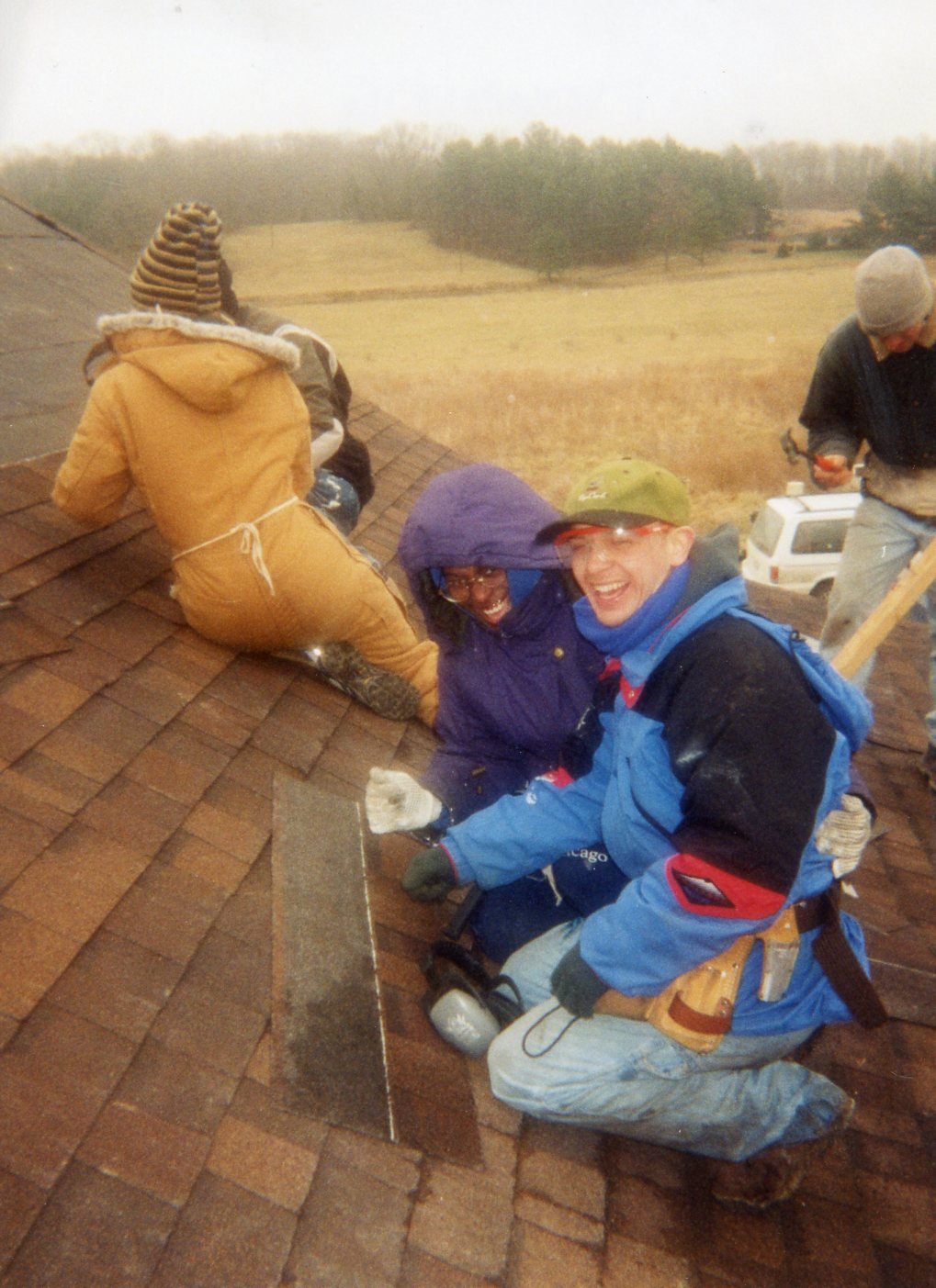 Students at WorkFest bundle up to repair a roof.