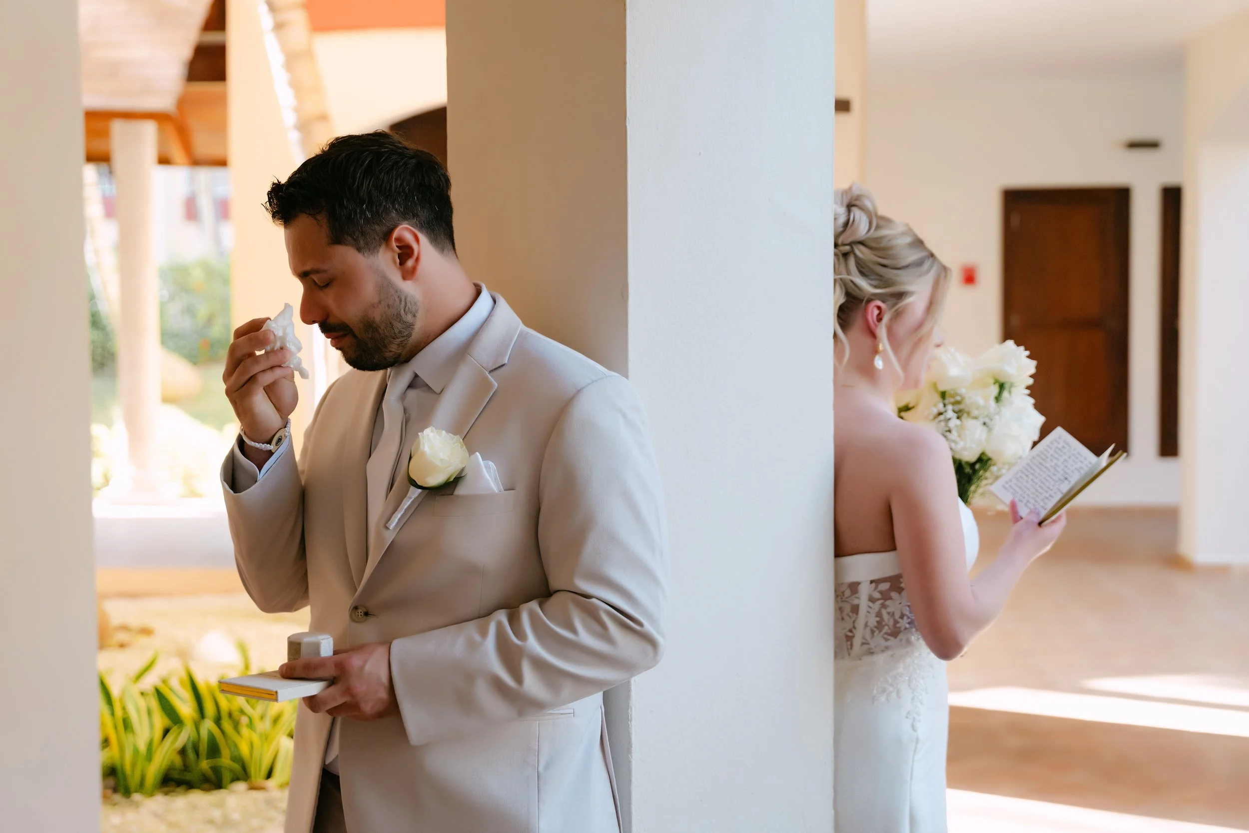 Groom wiping away a tear during an emotional back-to-back first look with his bride at Majestic Punta Cana