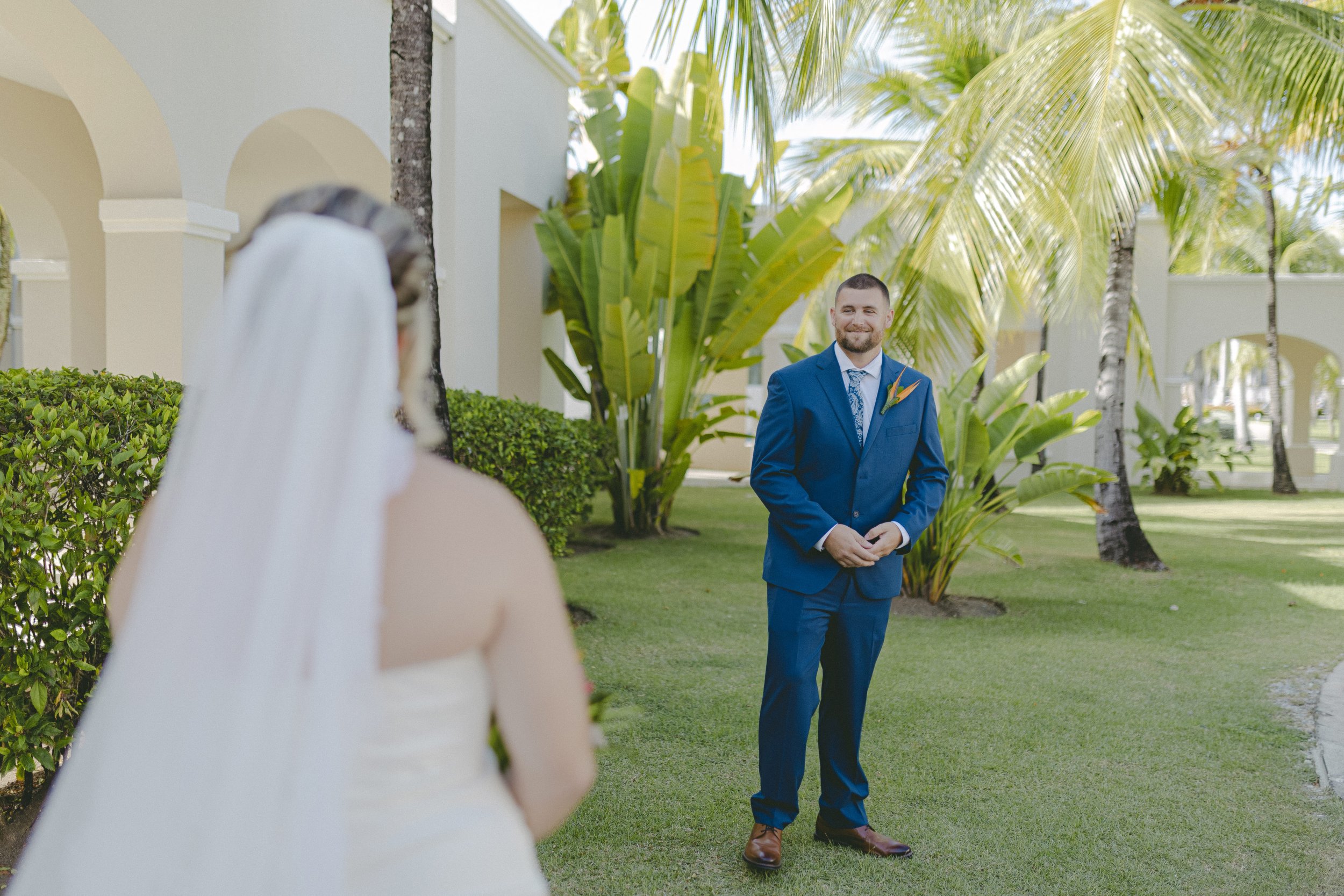 Groom's reaction during first look with bride at Dreams Royal Beach wedding