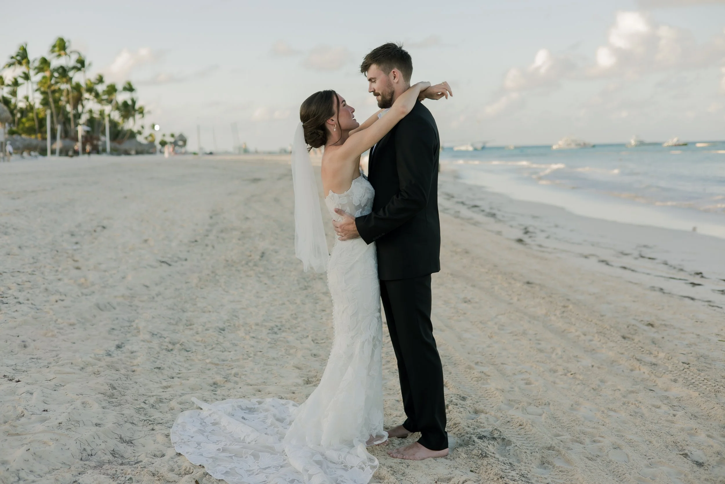 Bride and groom embracing on the beach at sunset, Punta Cana wedding photography by WBA Studio.