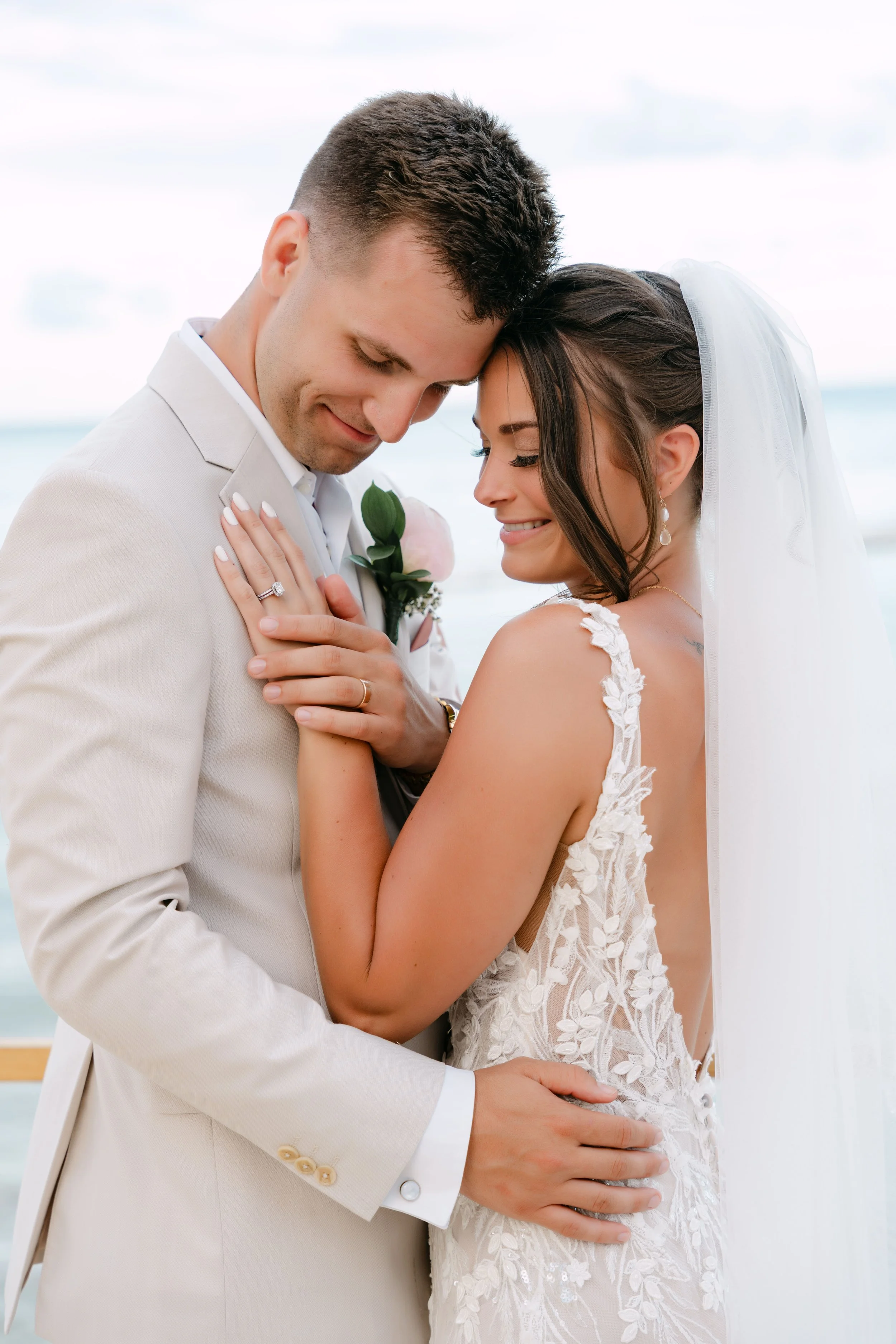 Romantic close-up portrait of the bride and groom embracing during their Punta Cana destination wedding.