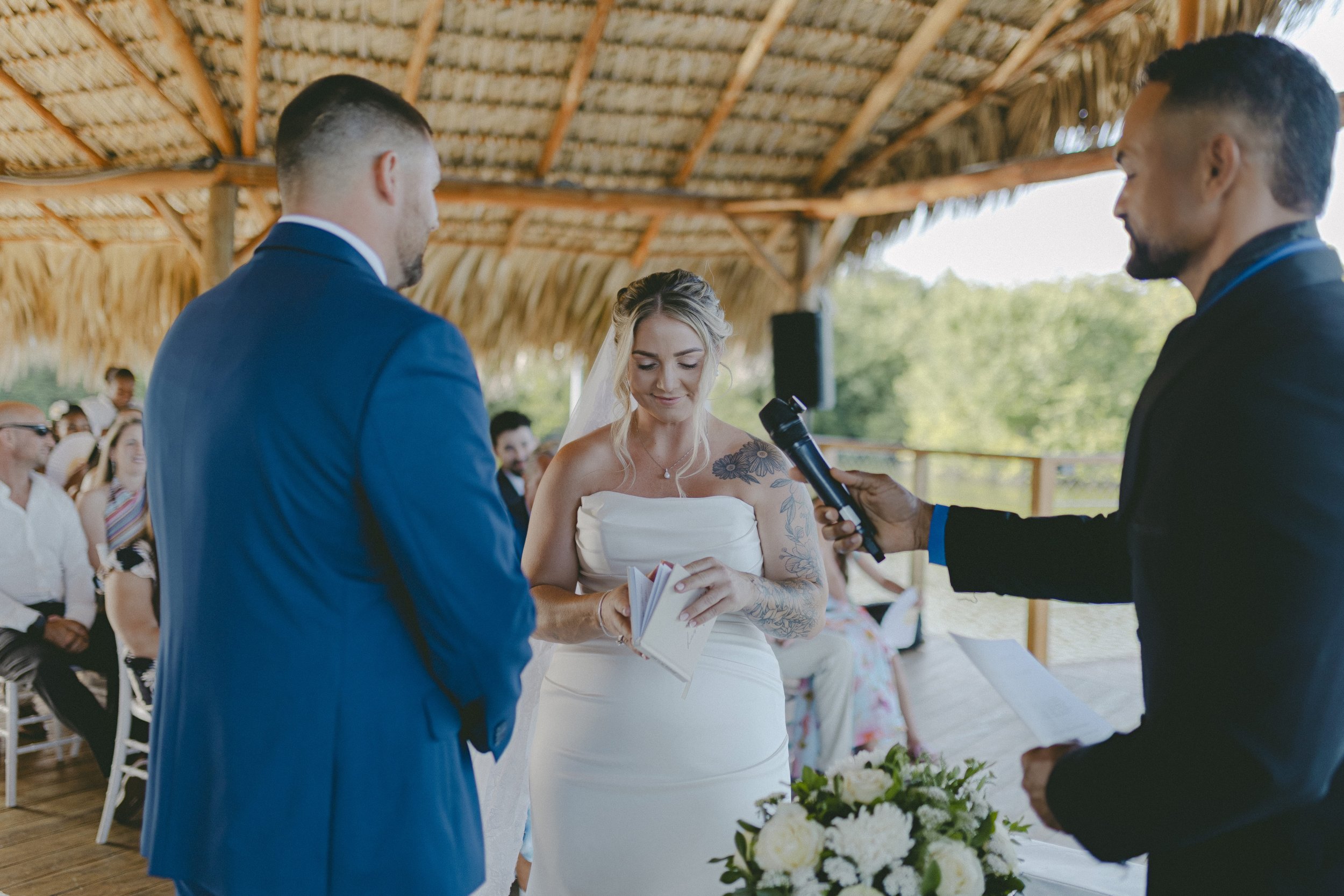 Bride reading vows during ceremony under palapa at Dreams Royal Beach