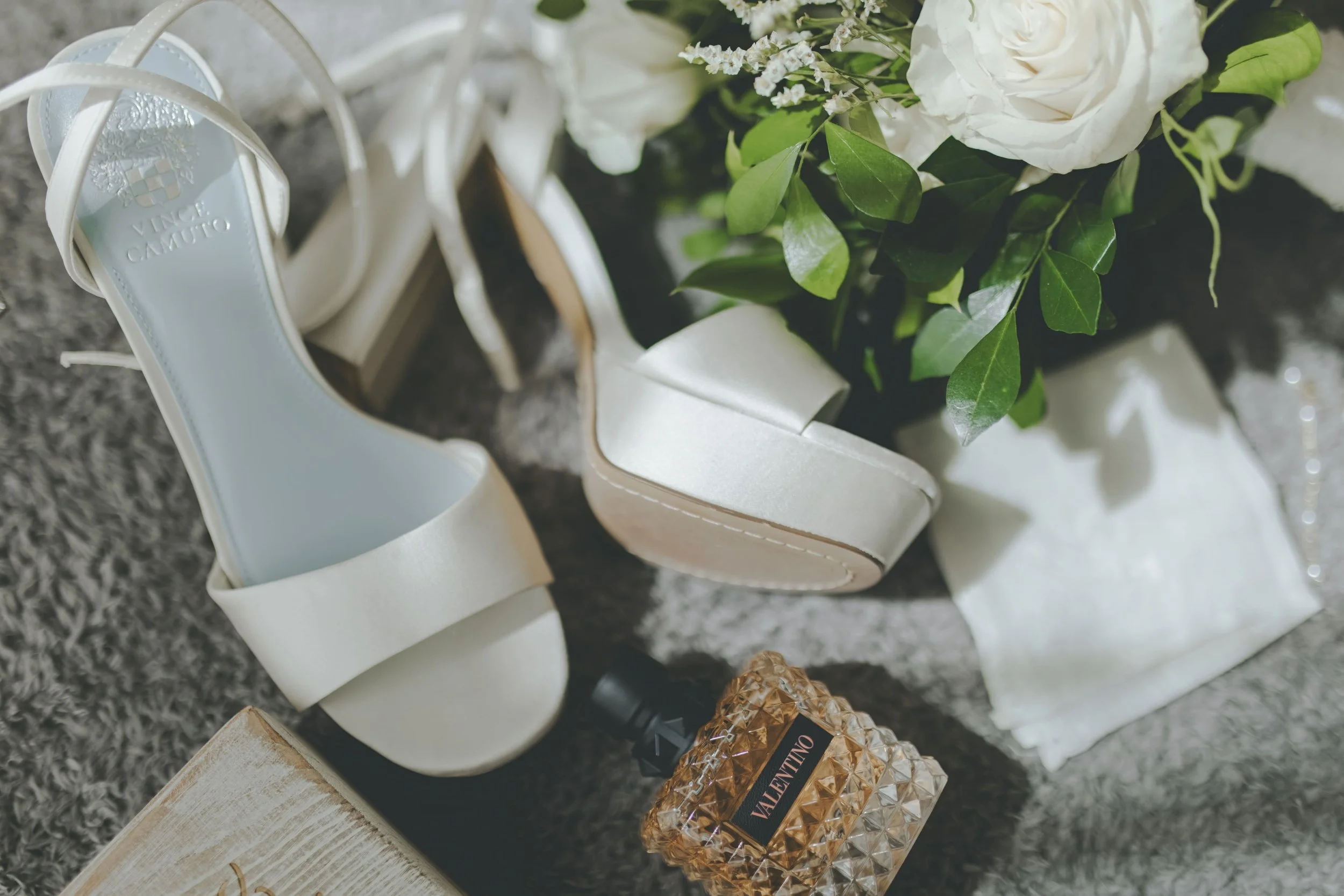 Bridal heels and jewelry with white roses in a wedding detail flat lay in Punta Cana