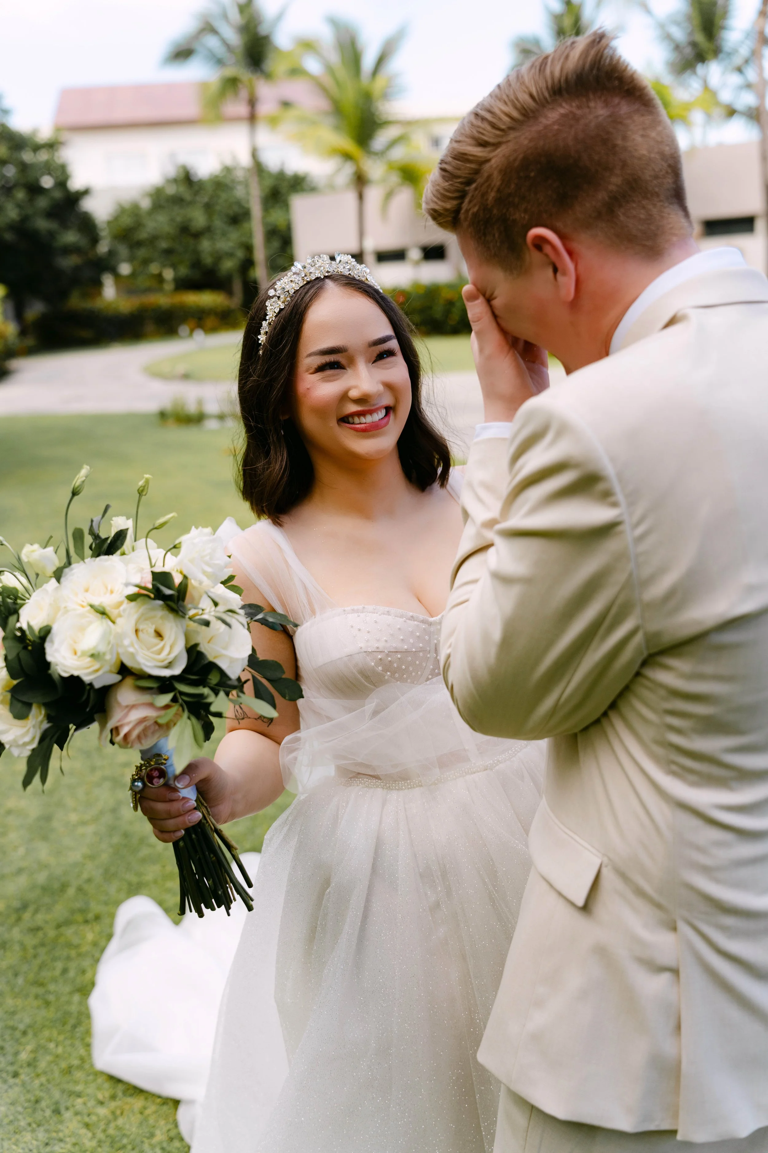 Groom wiping away tears during an emotional first look with his bride at Dreams Onyx Punta Cana