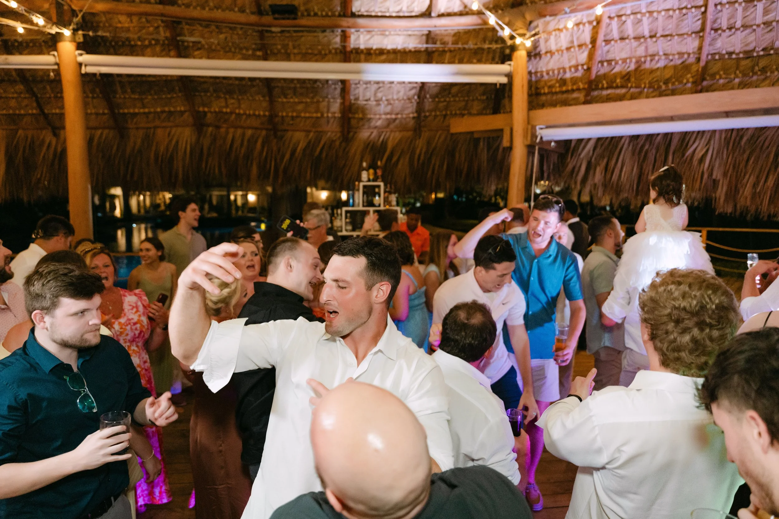 Wedding guests dancing and celebrating on the reception dance floor during a lively destination wedding in Punta Cana, Dominican Republic.