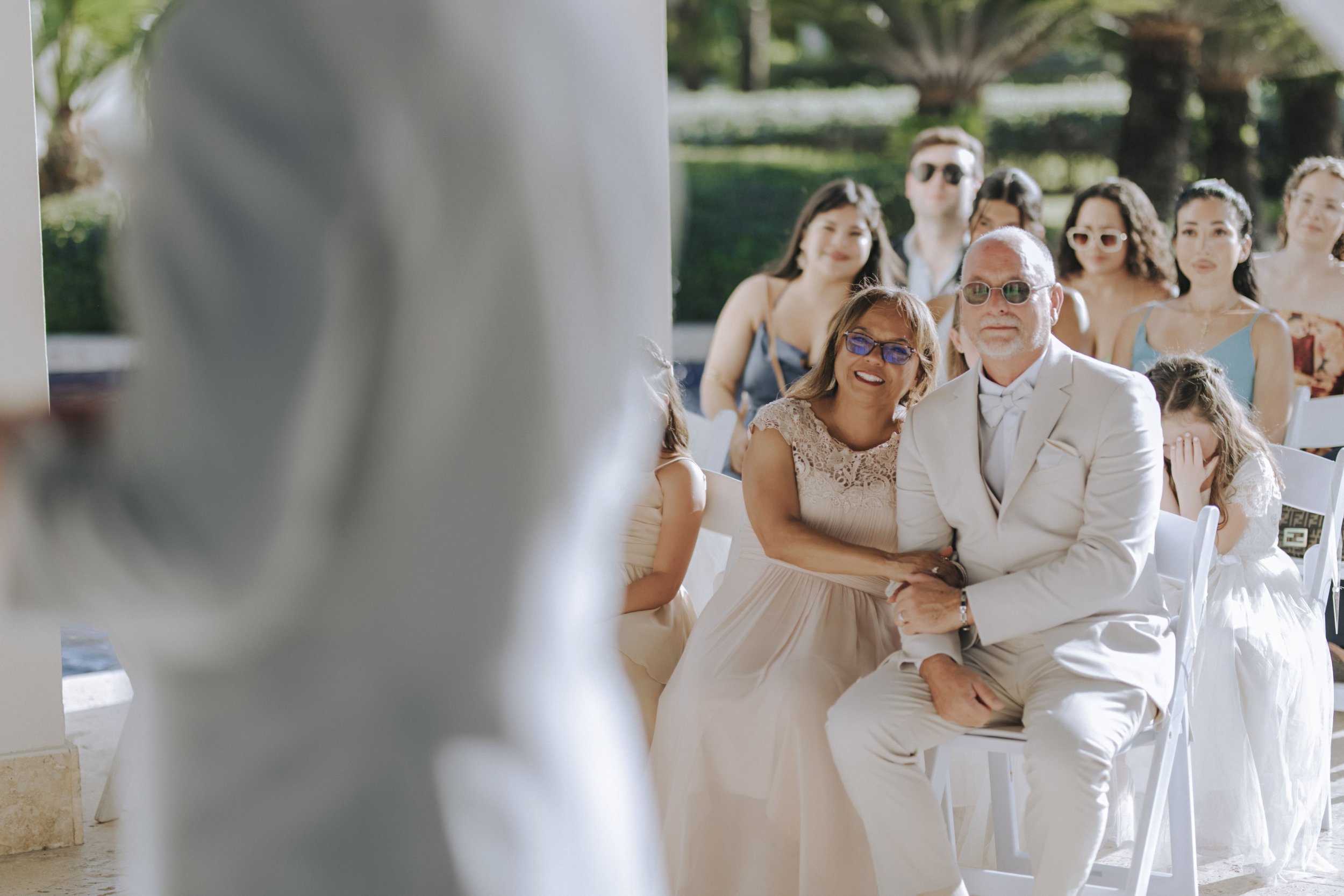 Wedding guests smiling and reacting during the ceremony at Dreams Onyx