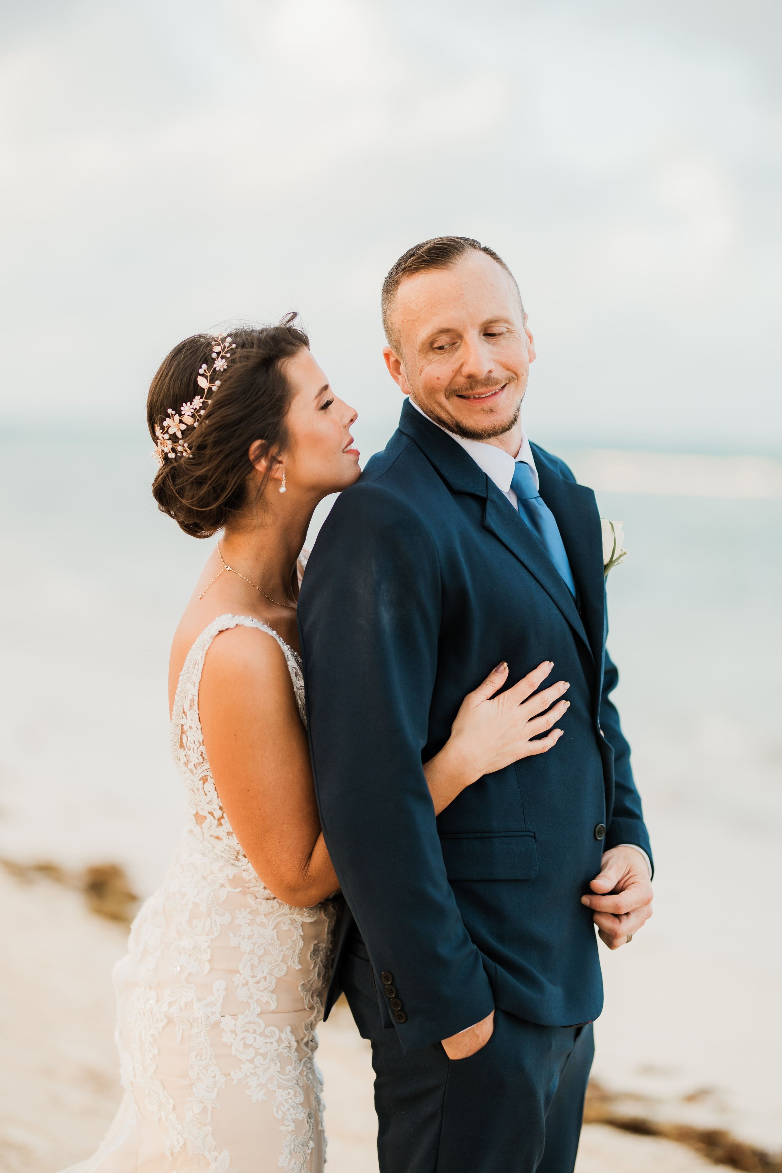 Bride and groom in a close embrace during portraits at Dreams Flora