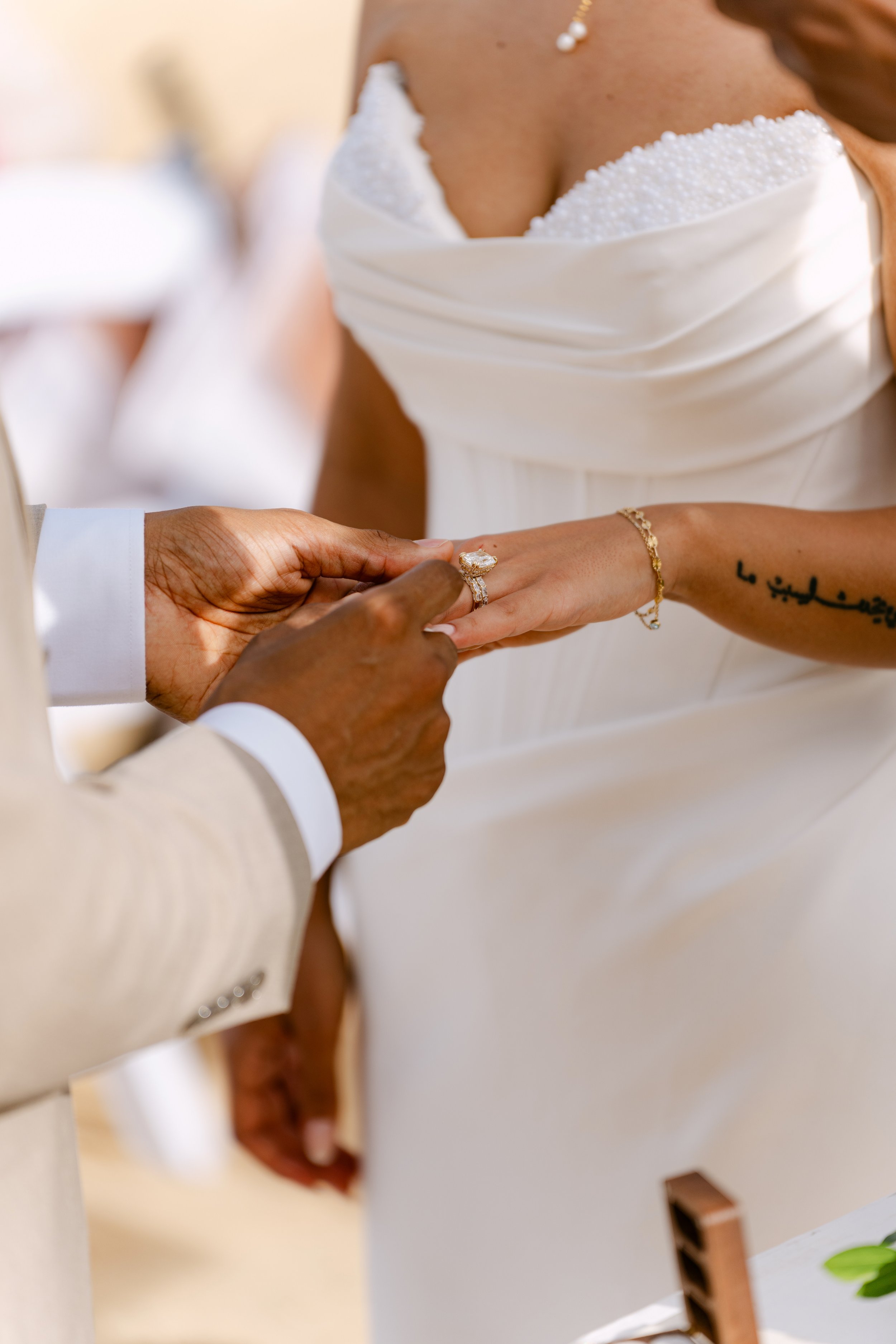 Groom slipping the wedding ring onto the bride’s finger during the ceremony